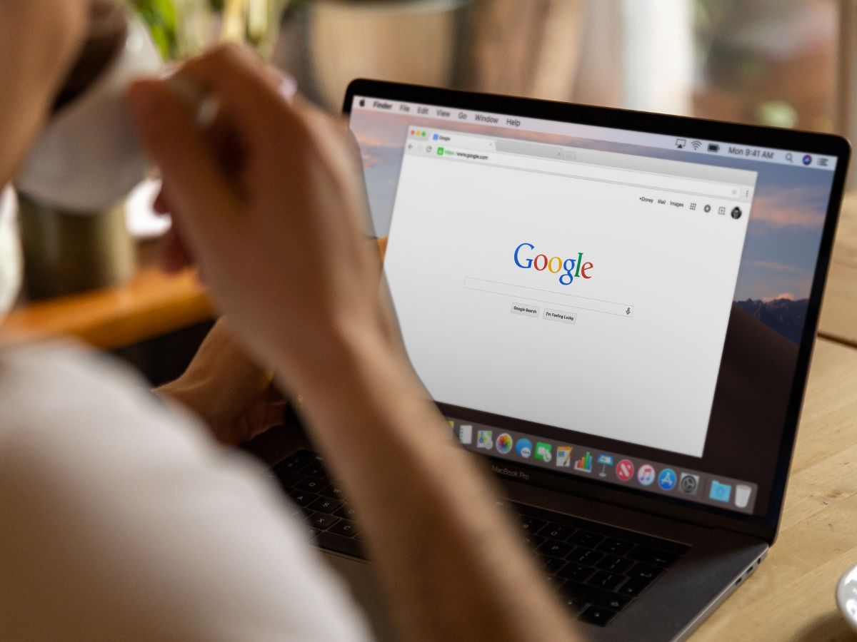 Man and a laptop with Google on screen