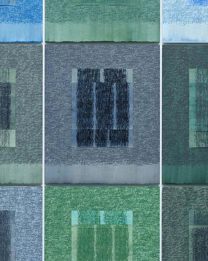 Grid of nine stitched textile panels in blues and greens, each worked into a window-like rectangle