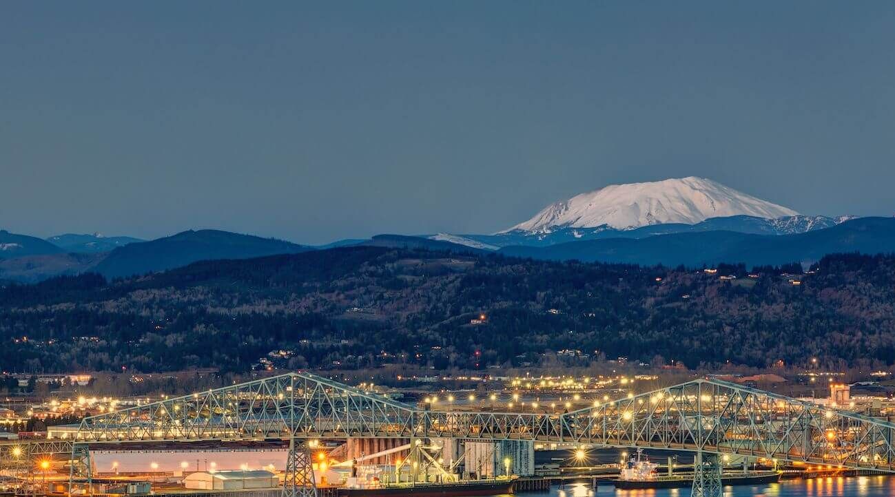 Image of the ports on the Columbia River in Longview, WA at dusk with Mt. St. Helens in the background