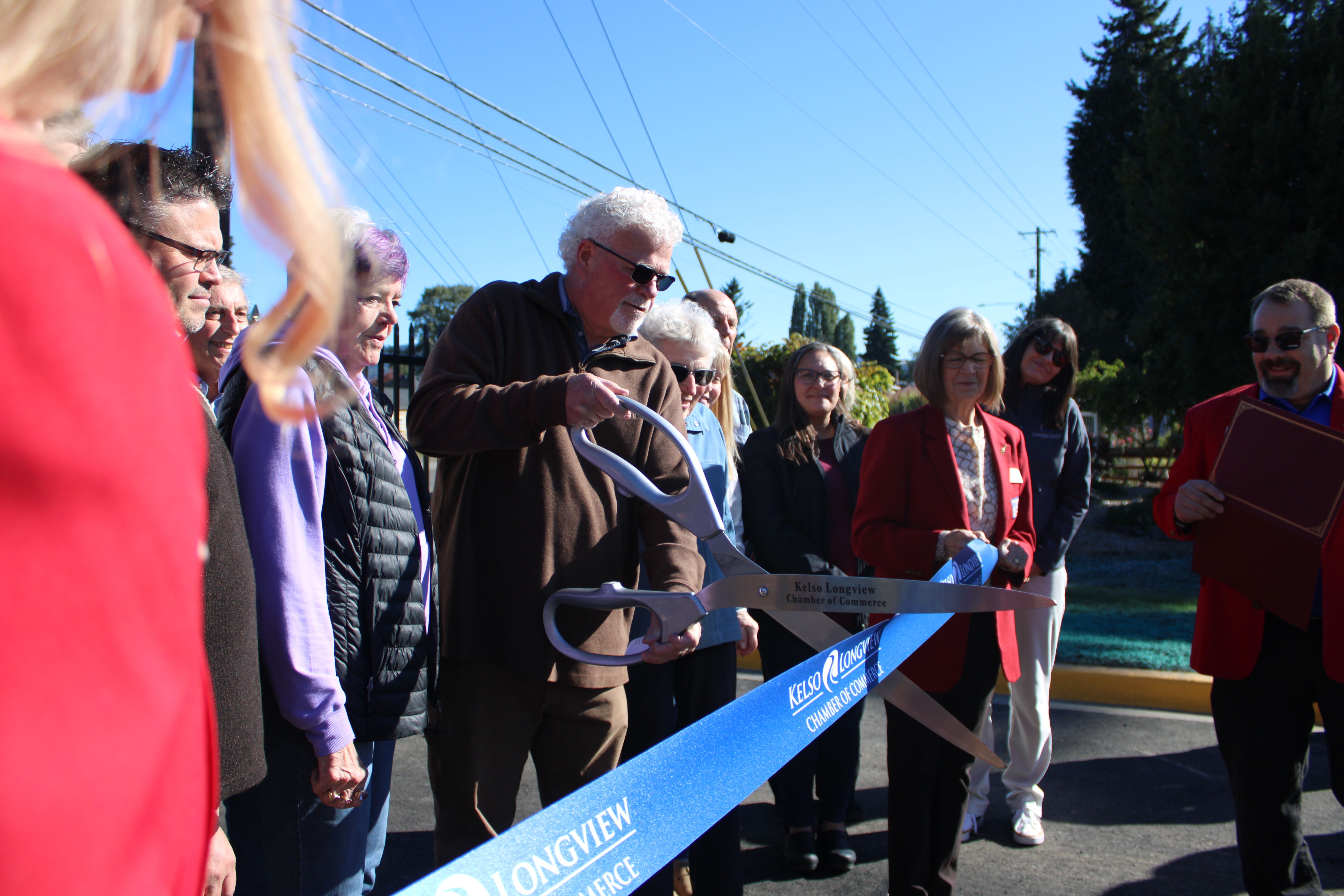 Bob Gregory with the Cowlitz PFD cutting the ribbon to open the new Event Center Entryway