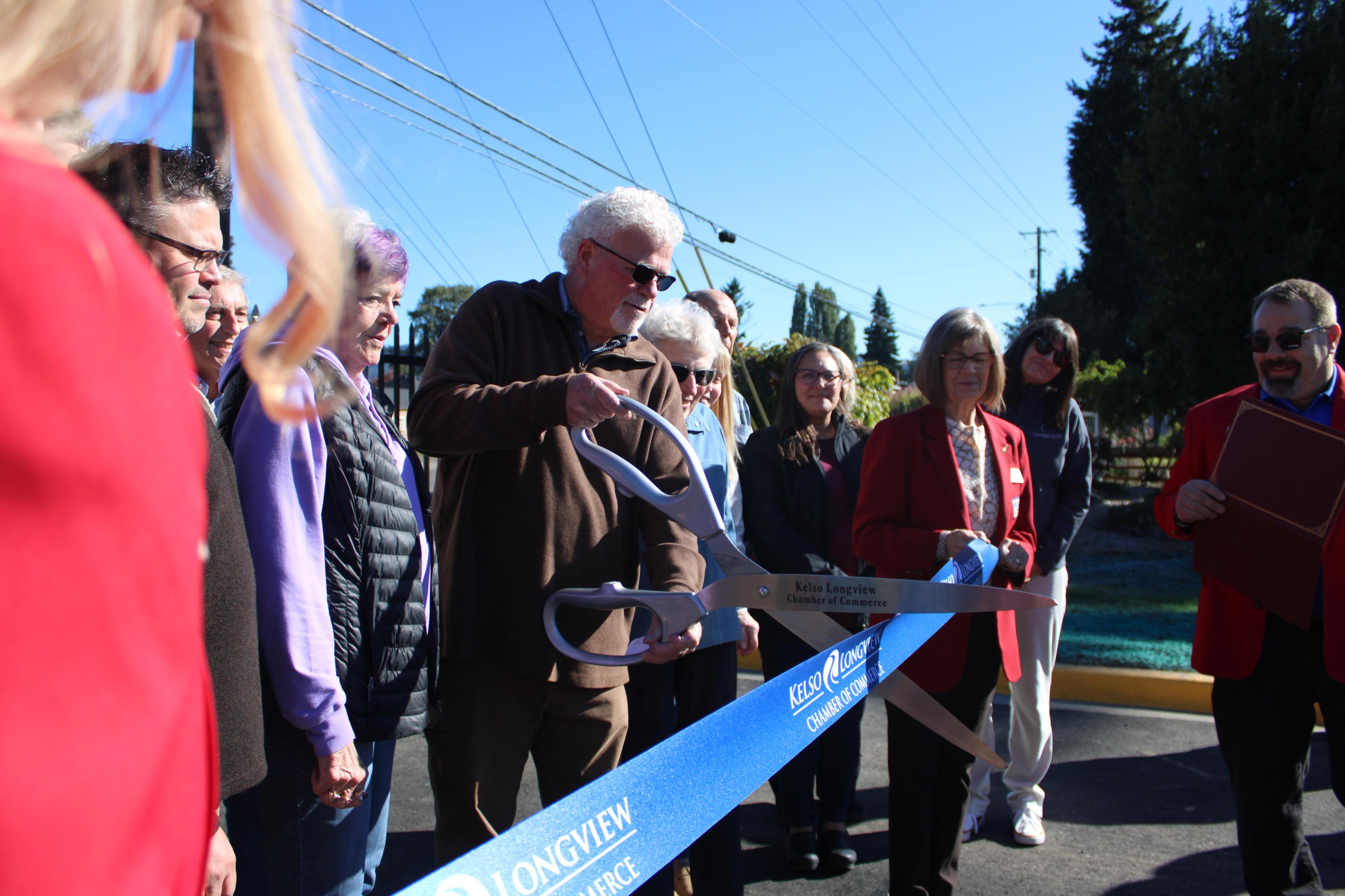Bob Gregory with the Cowlitz PFD cutting the ribbon to open the new Event Center Entryway
