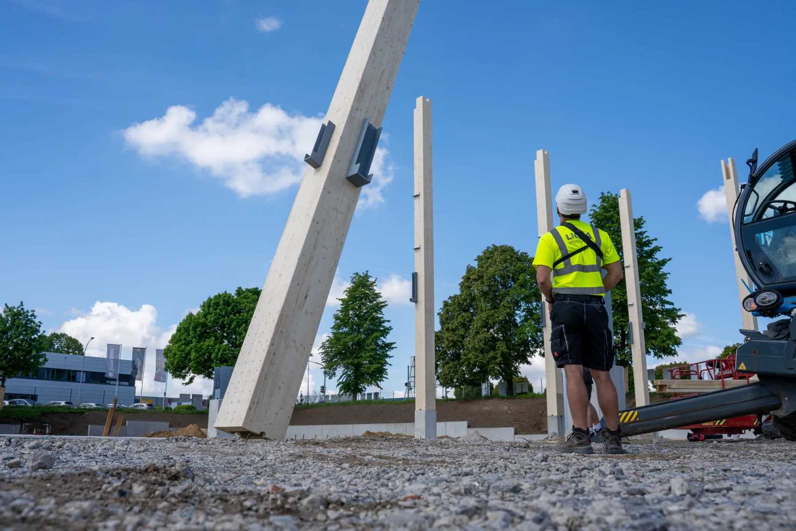 Installing a timber column with the crane on site