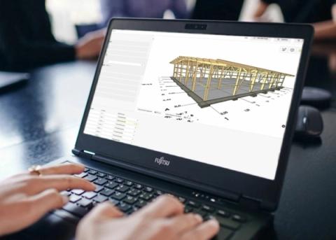 Architect planning a timber structure on a 3D model on a laptop