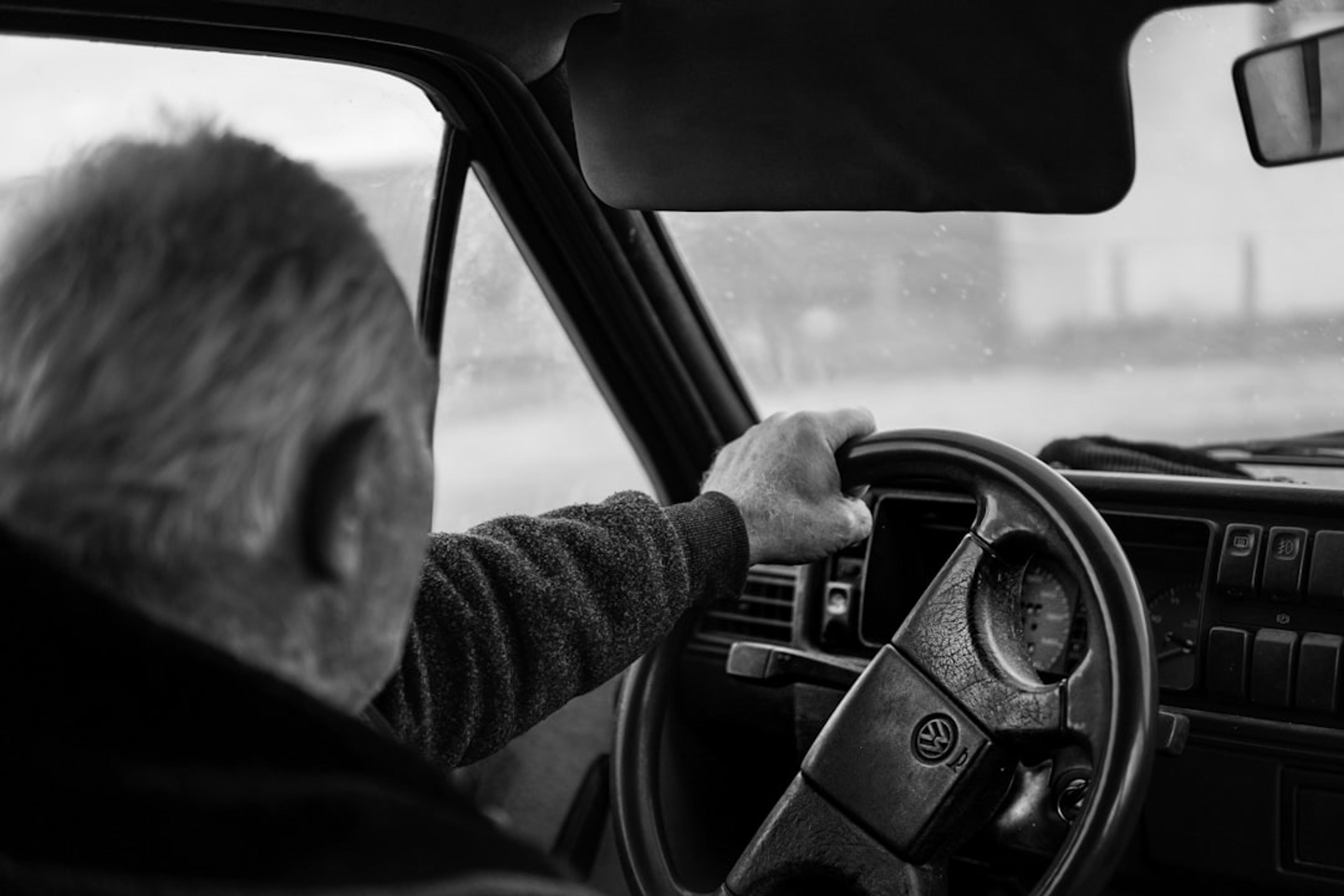 Man driving a car on a blurry day