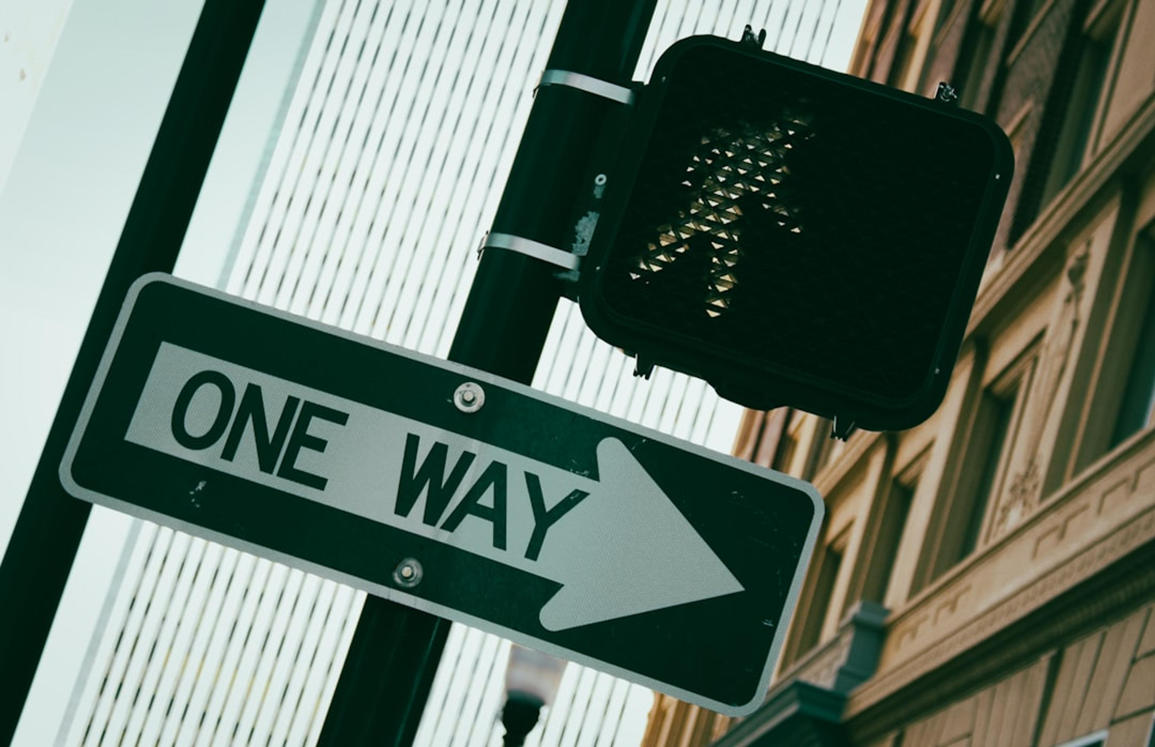 a close up of a street sign in front of a building