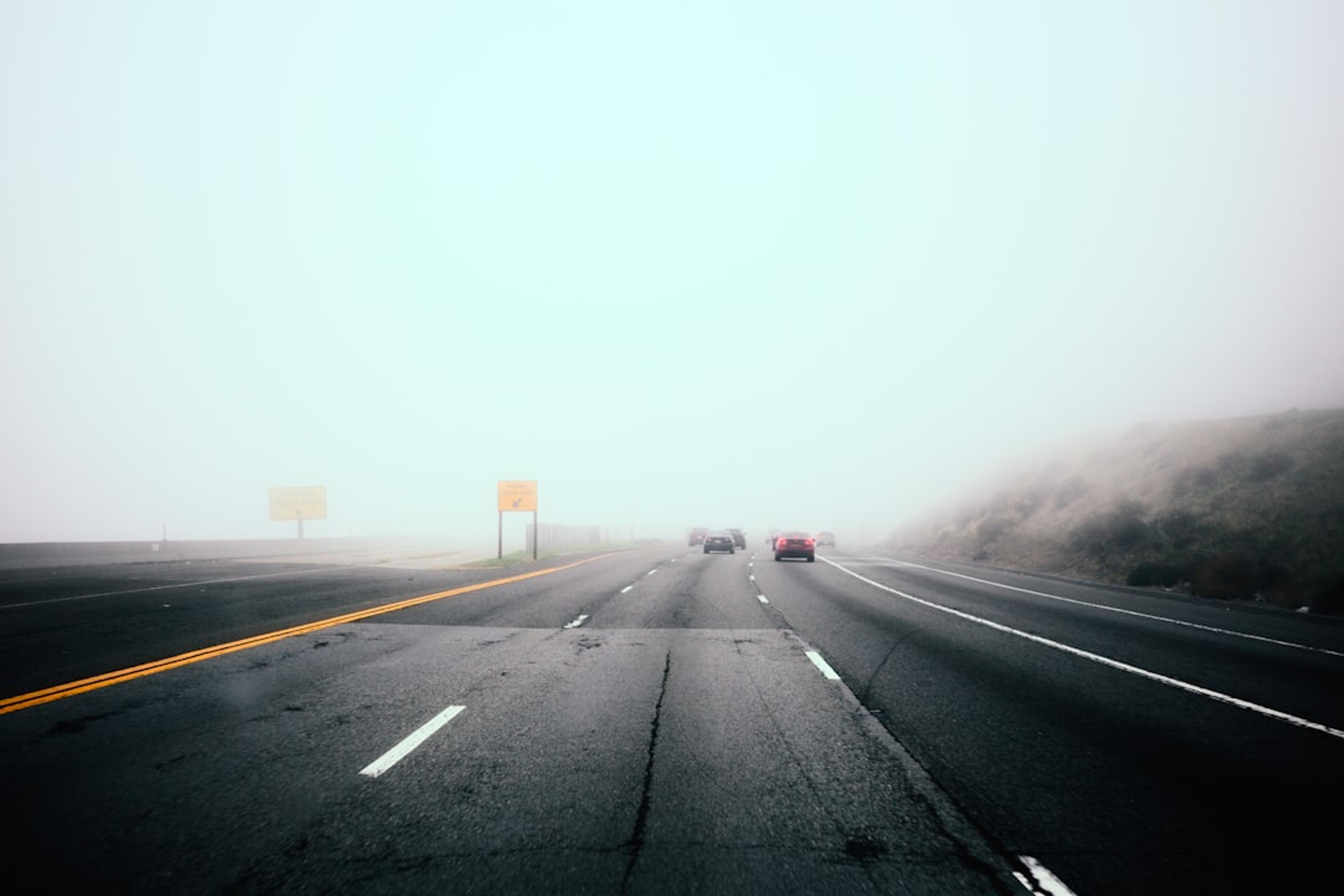 Cars driving on a foggy highway