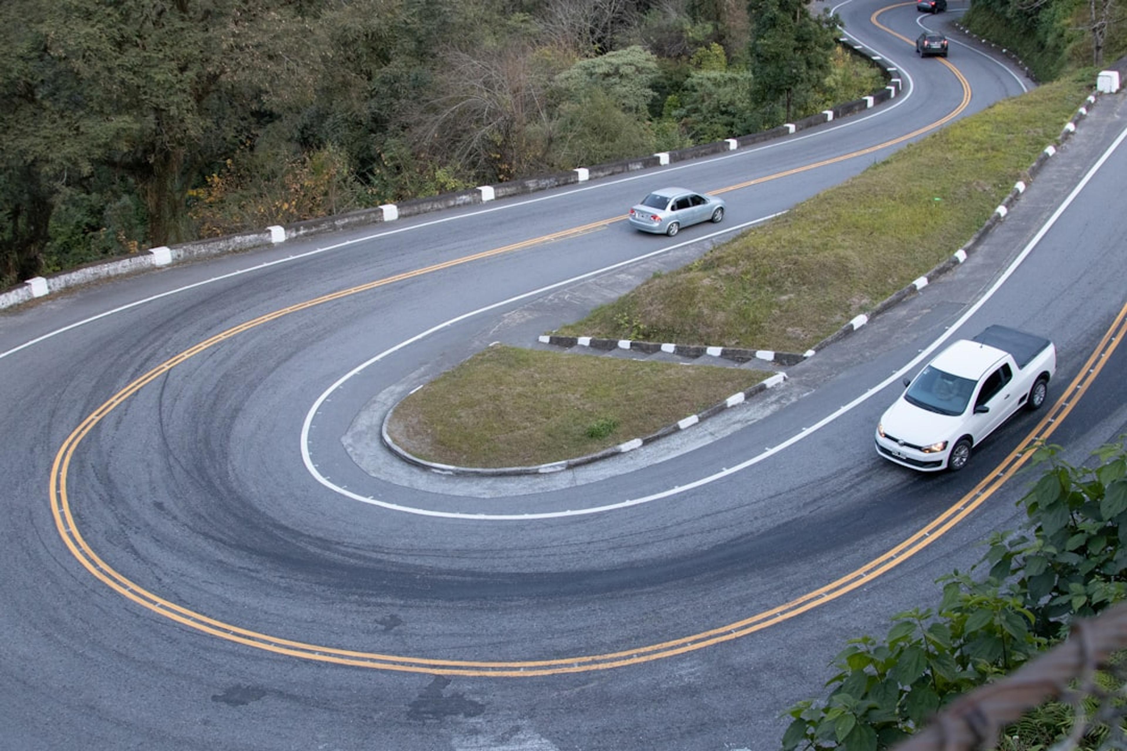 cars driving on a road with Nürburgring in the background