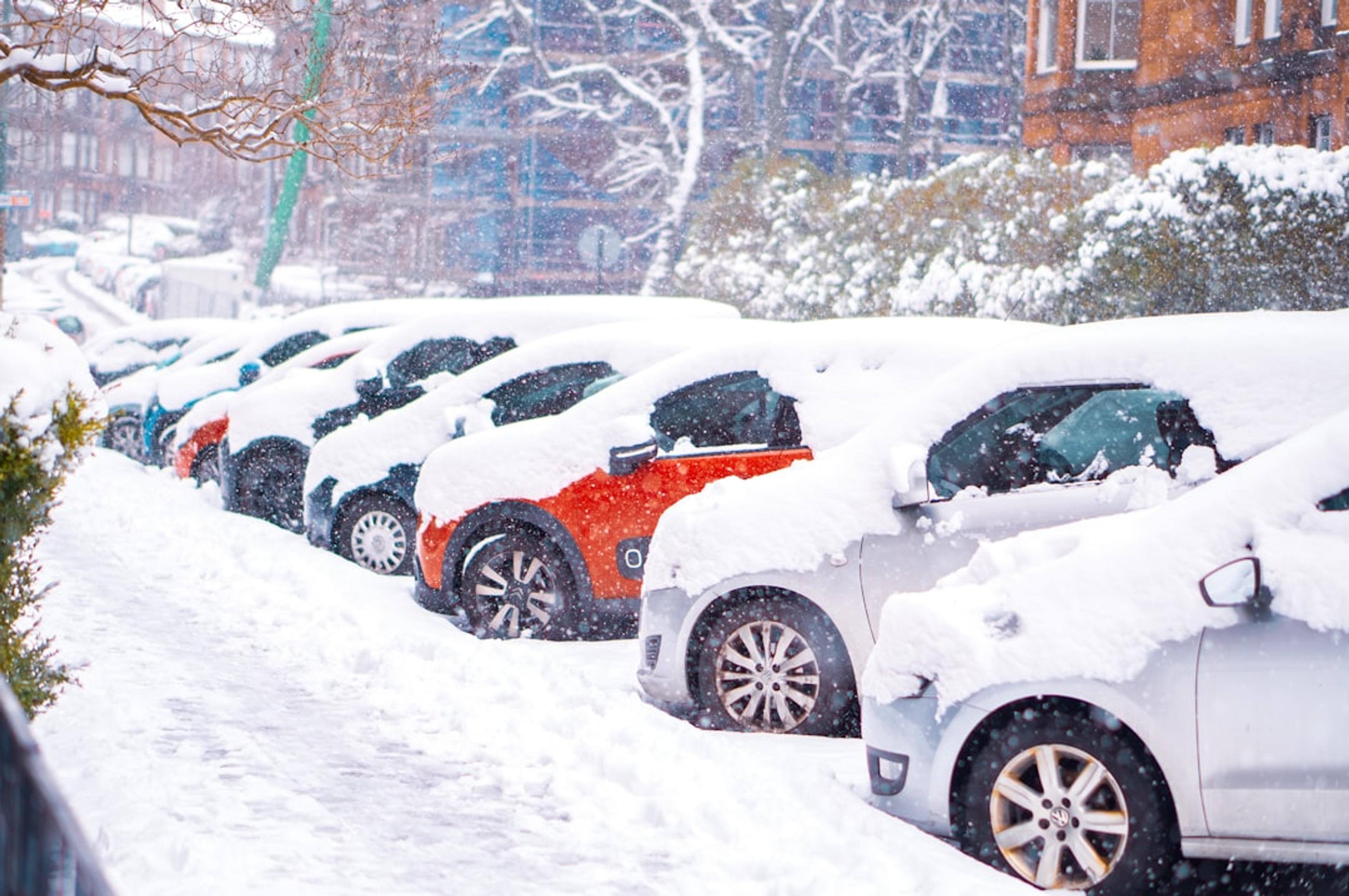 black suv covered with snow