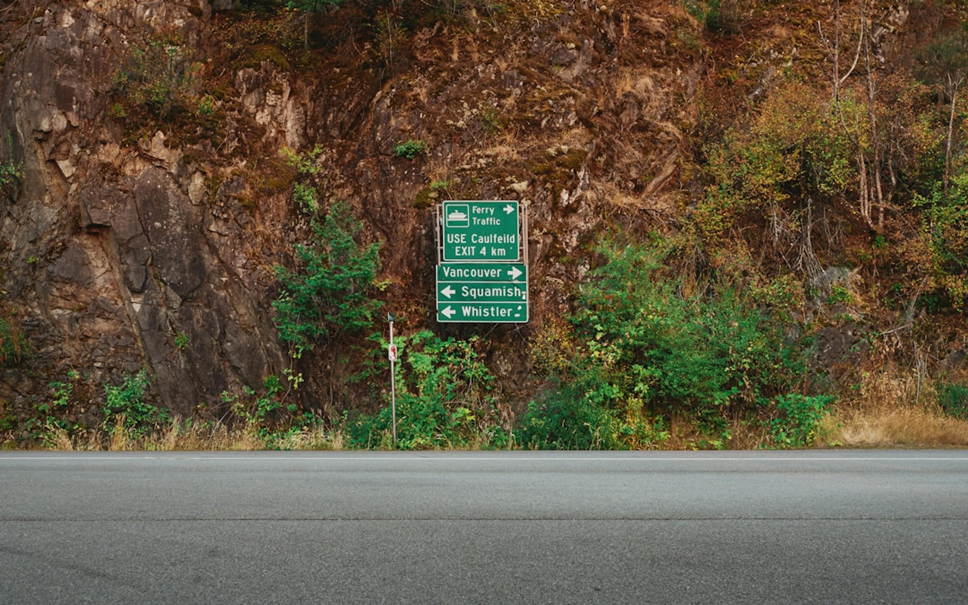 Roadside sign on a rocky hillside