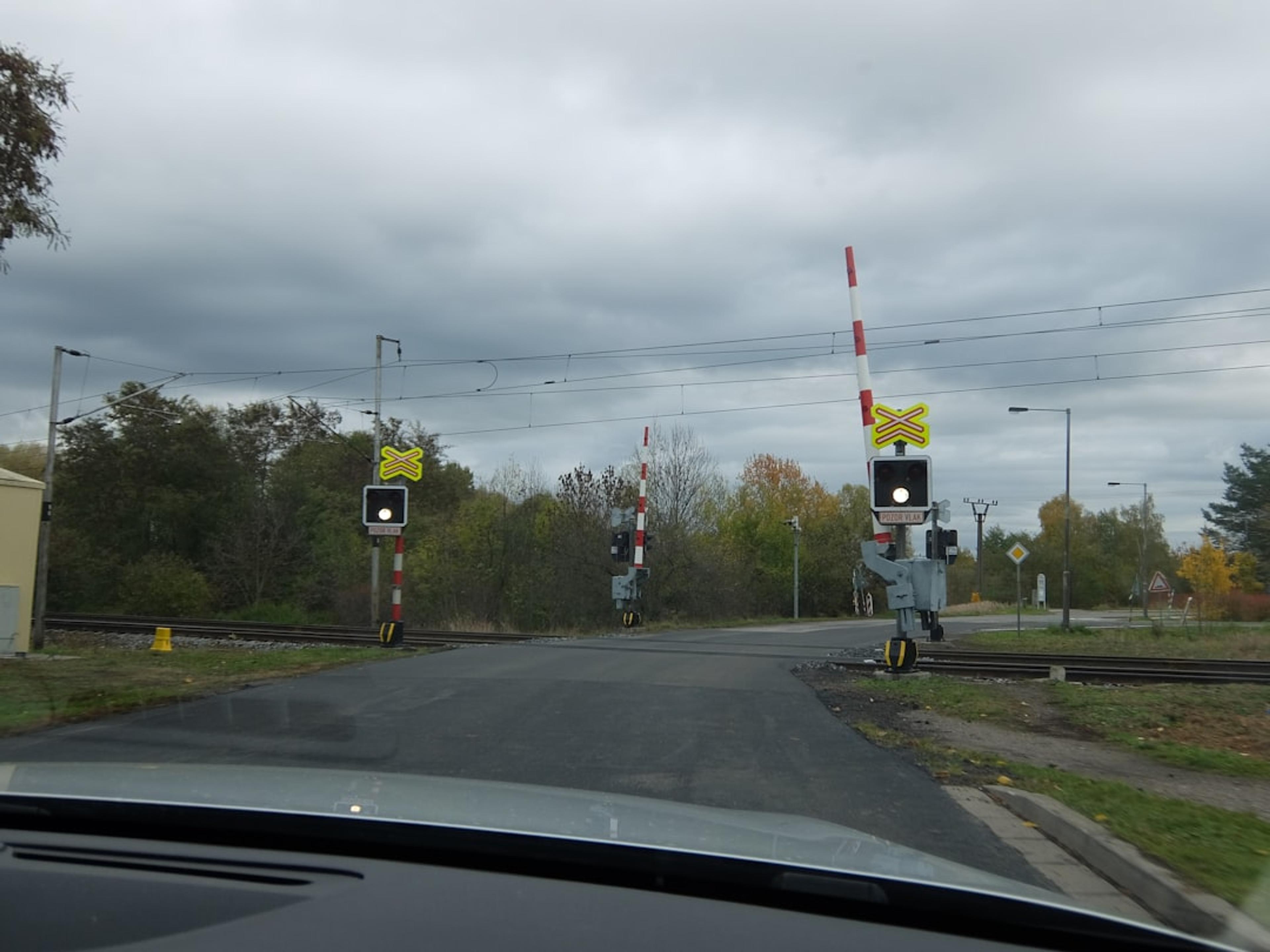 Train crossing with barriers and flashing lights