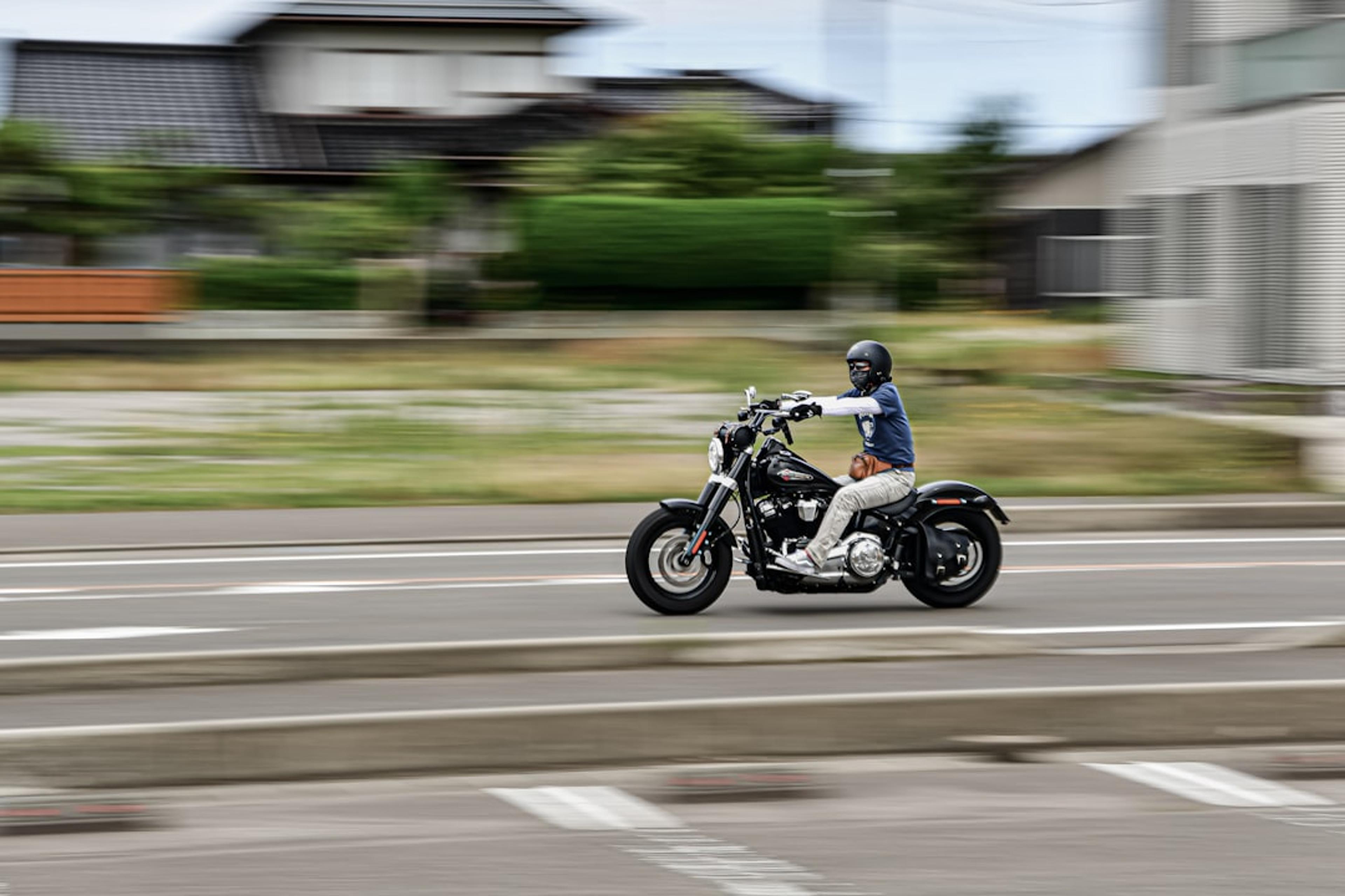 A man riding a motorcycle down a street