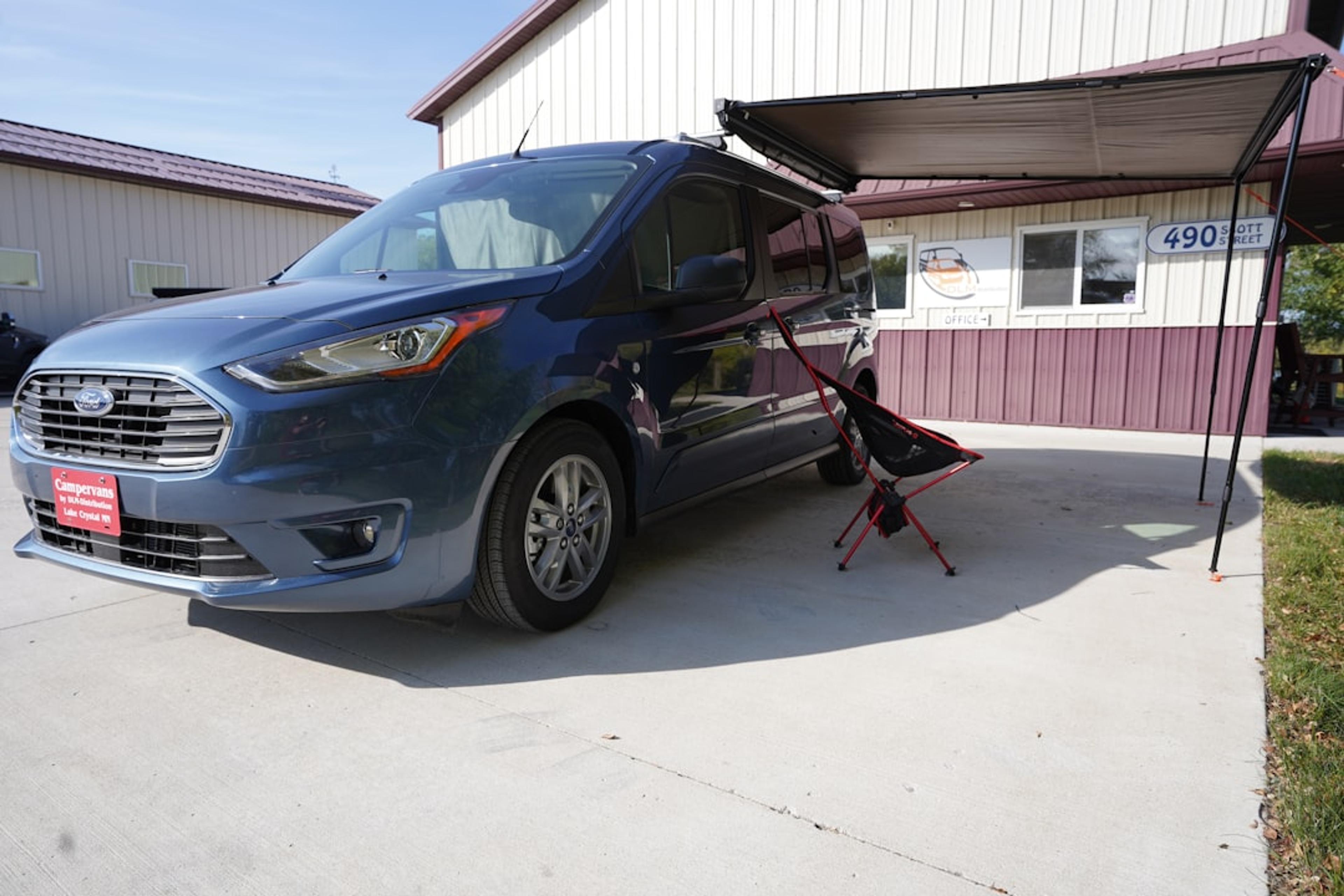 a blue van parked in front of a building