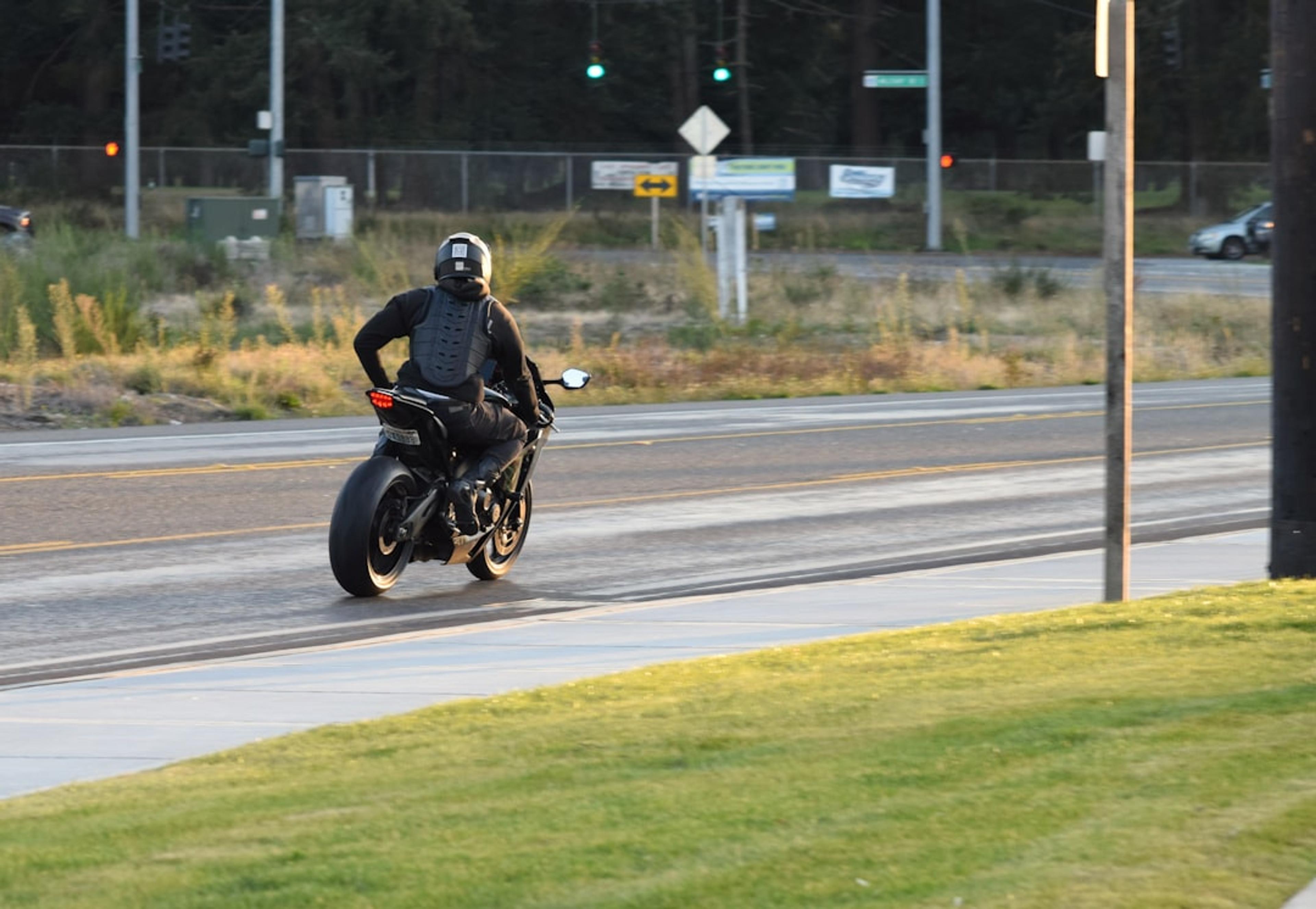A man riding a motorcycle down a curvy road