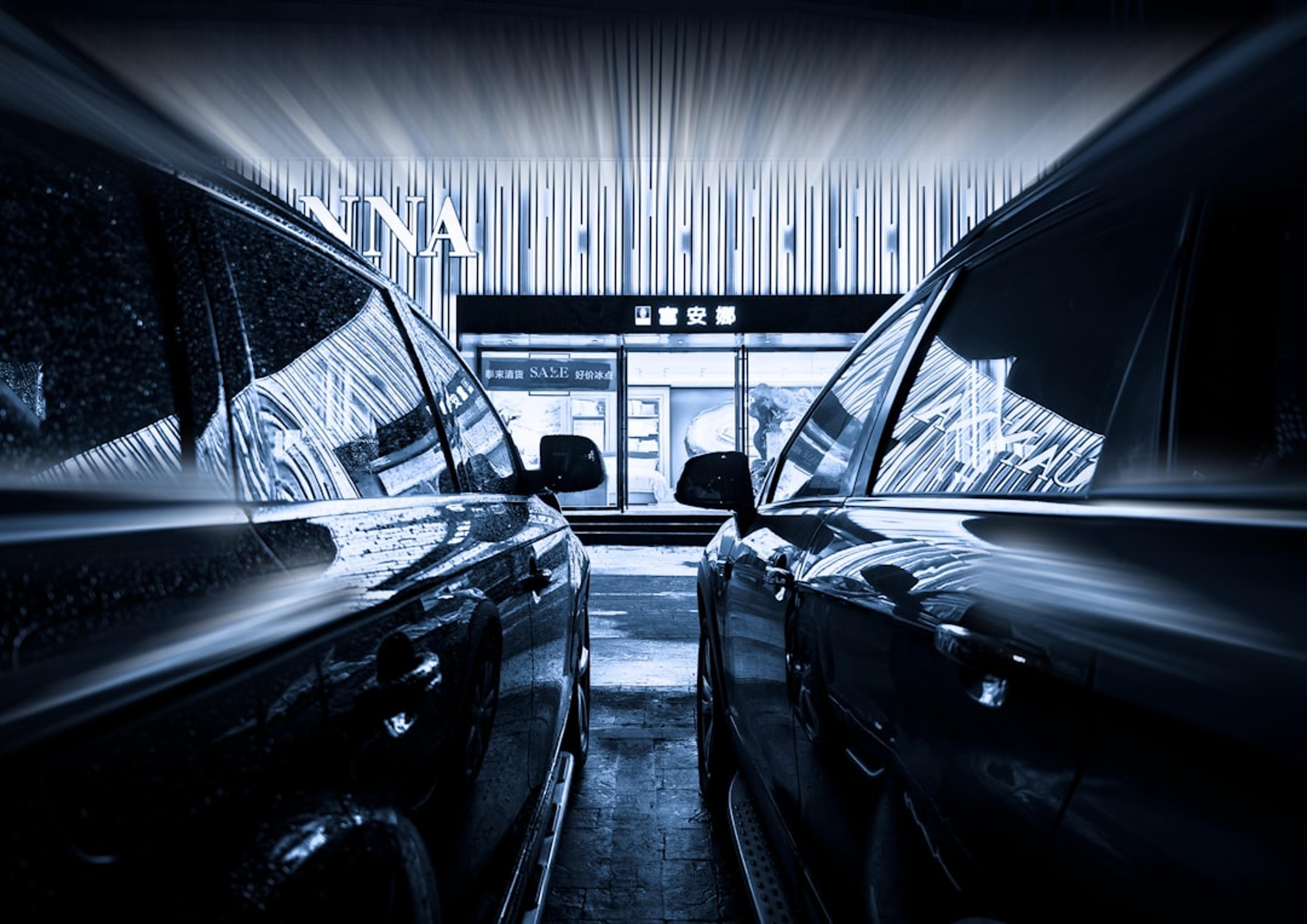A black and white photo of a car showroom