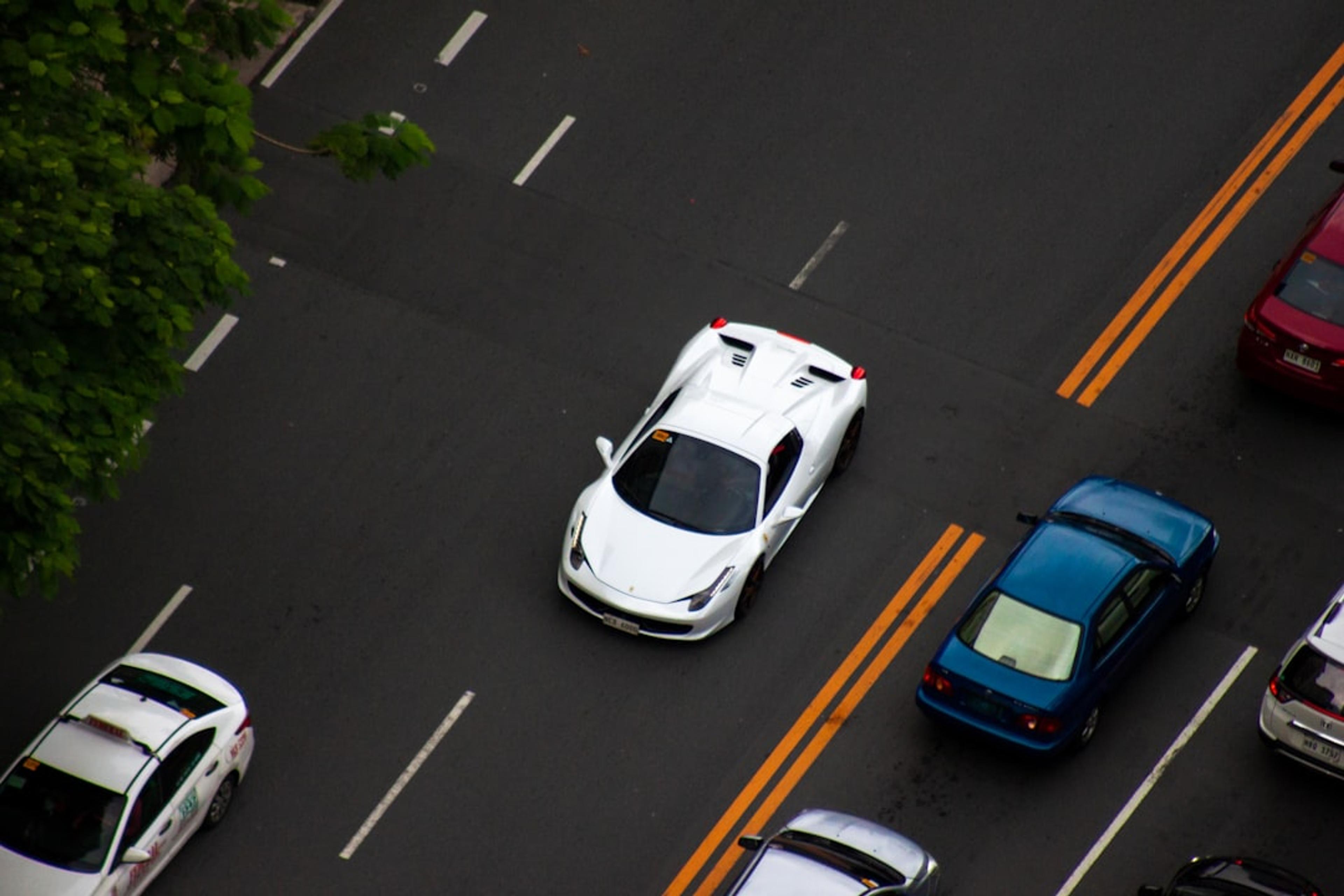 A street filled with lots of different colored cars
