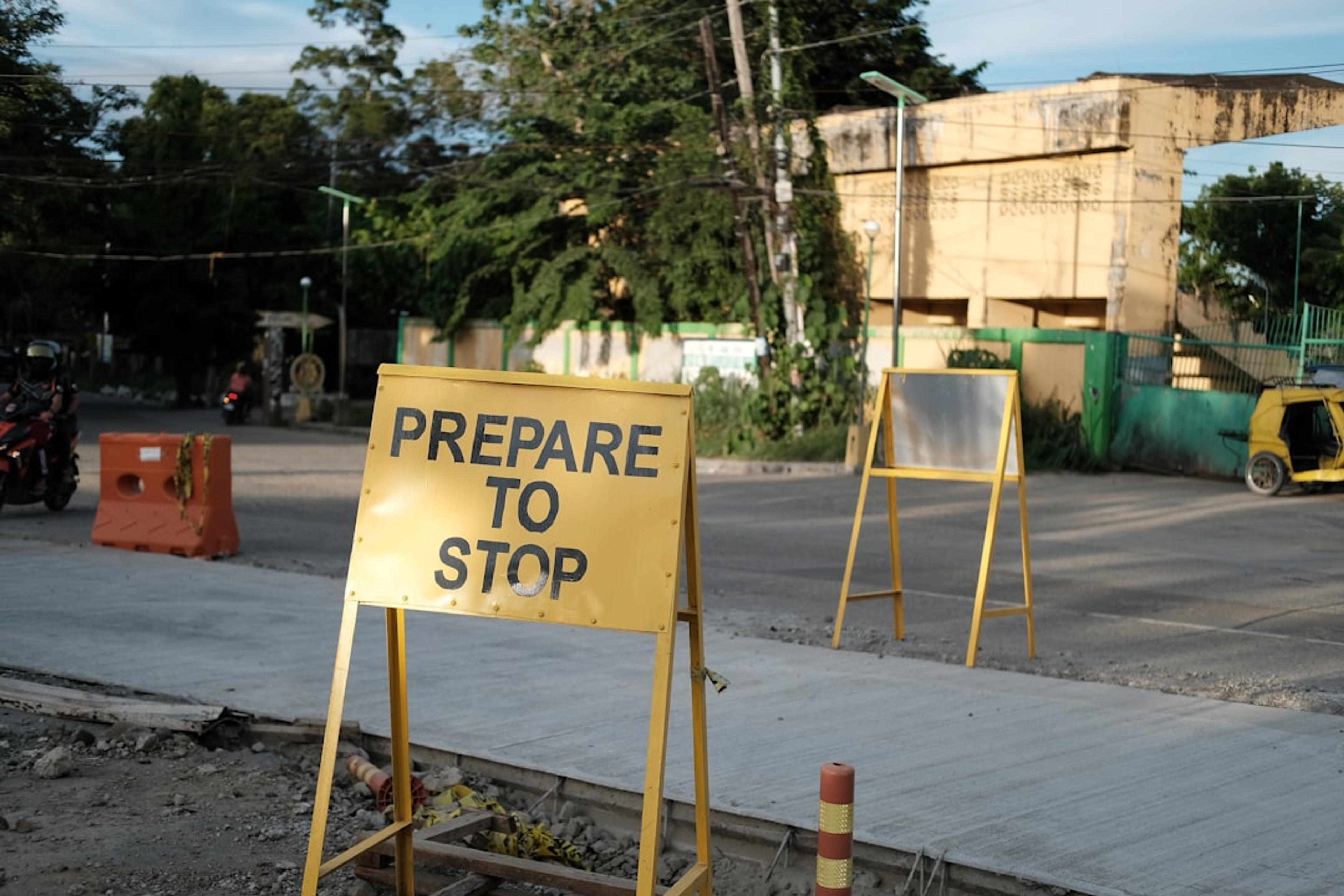 A sign that says prepare to stop on the side of the road