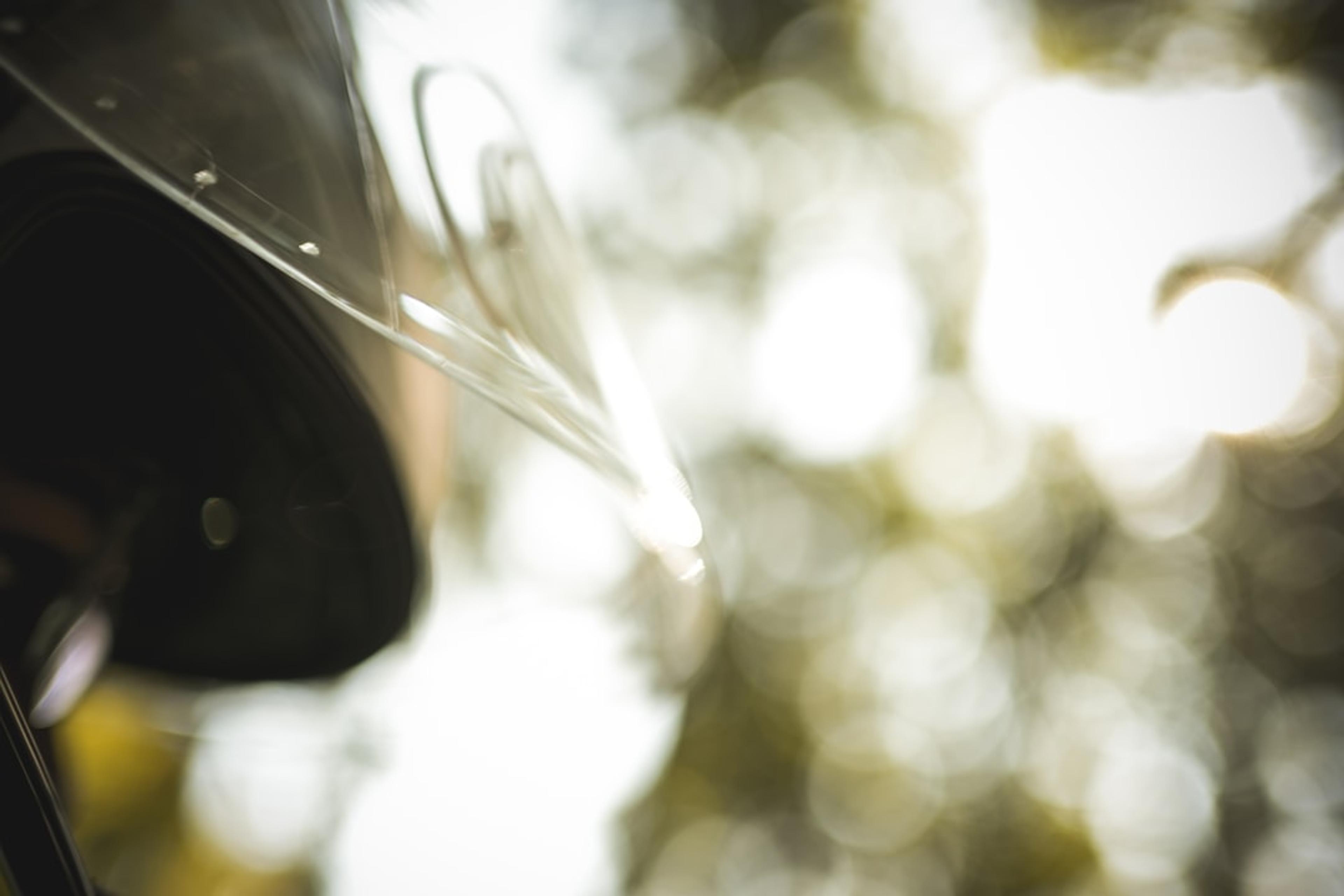 Close-up of a motorcycle windshield with bokeh background