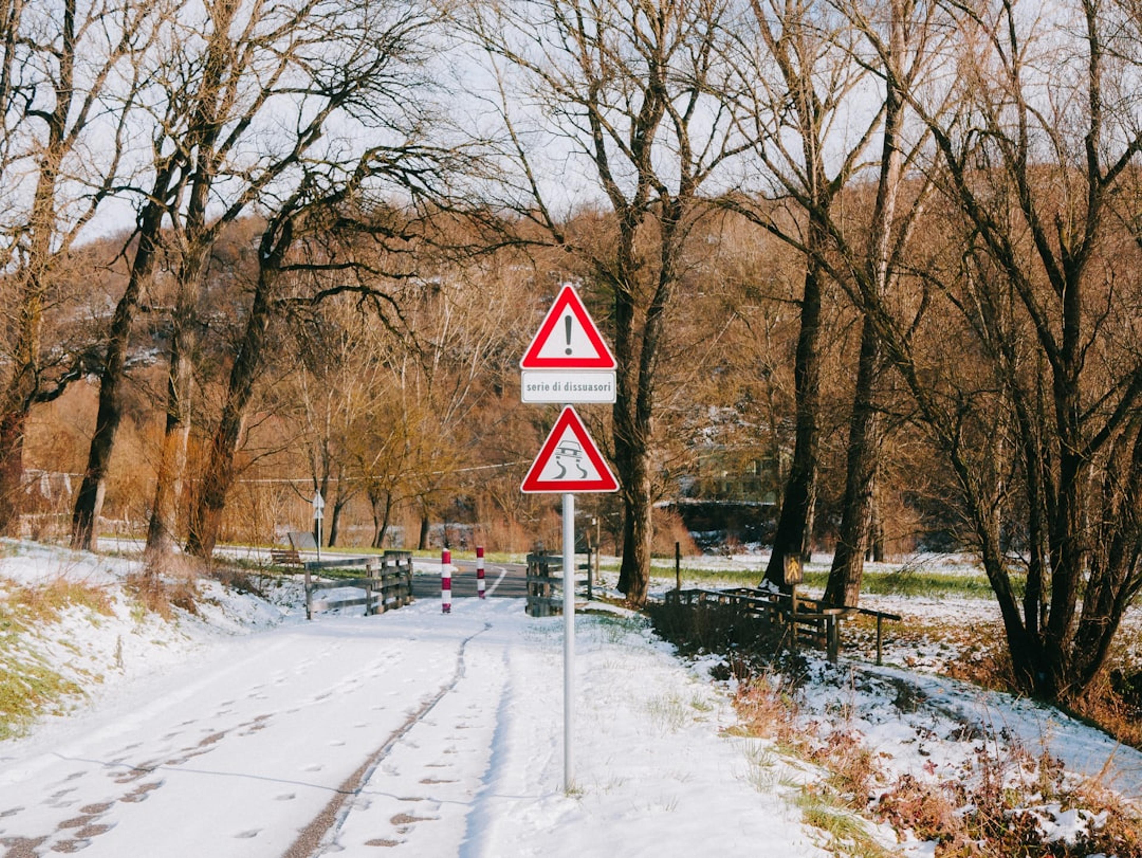 Two traffic signs on a snowy road