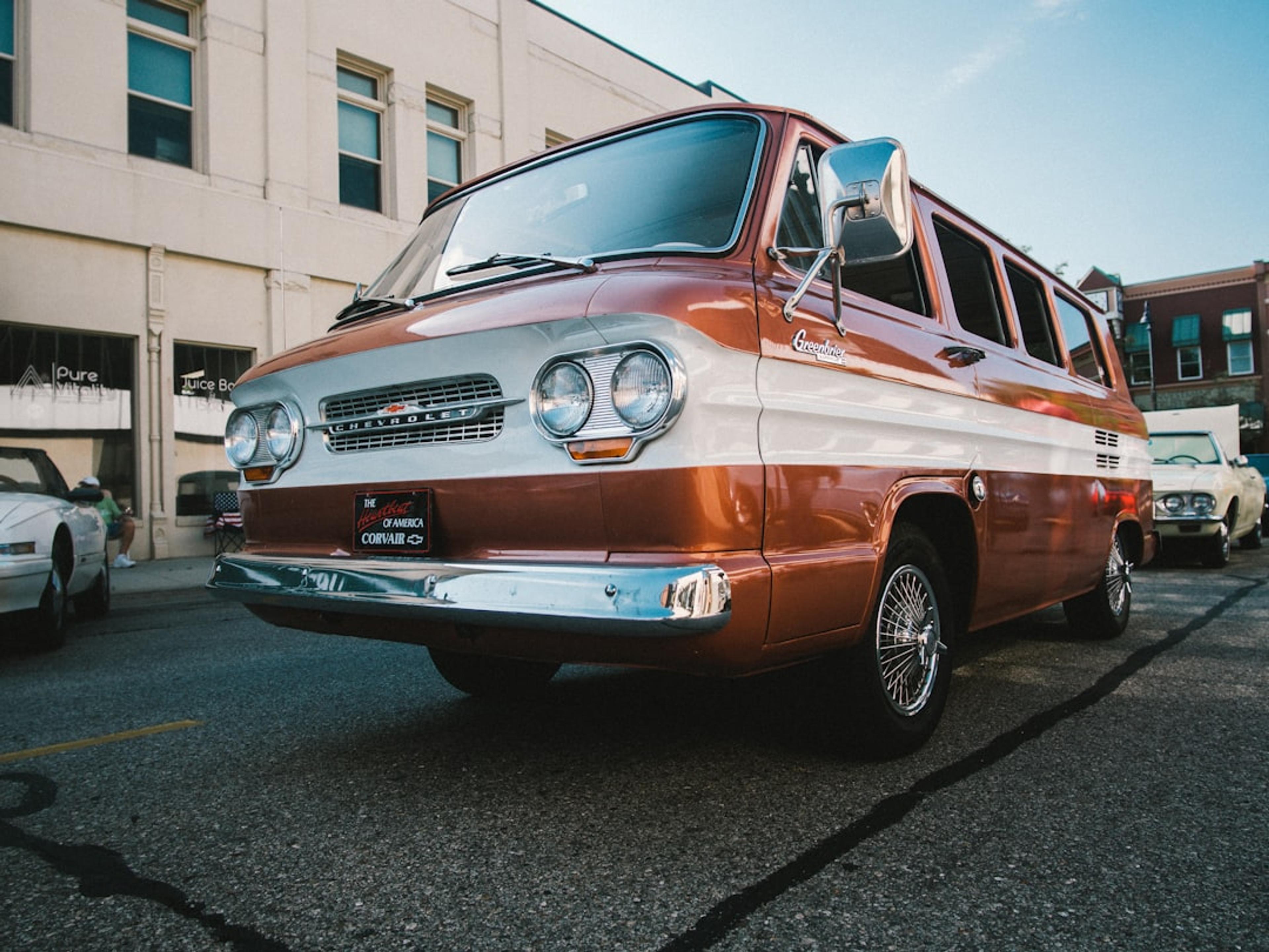 red chevrolet car parked on road side during daytime