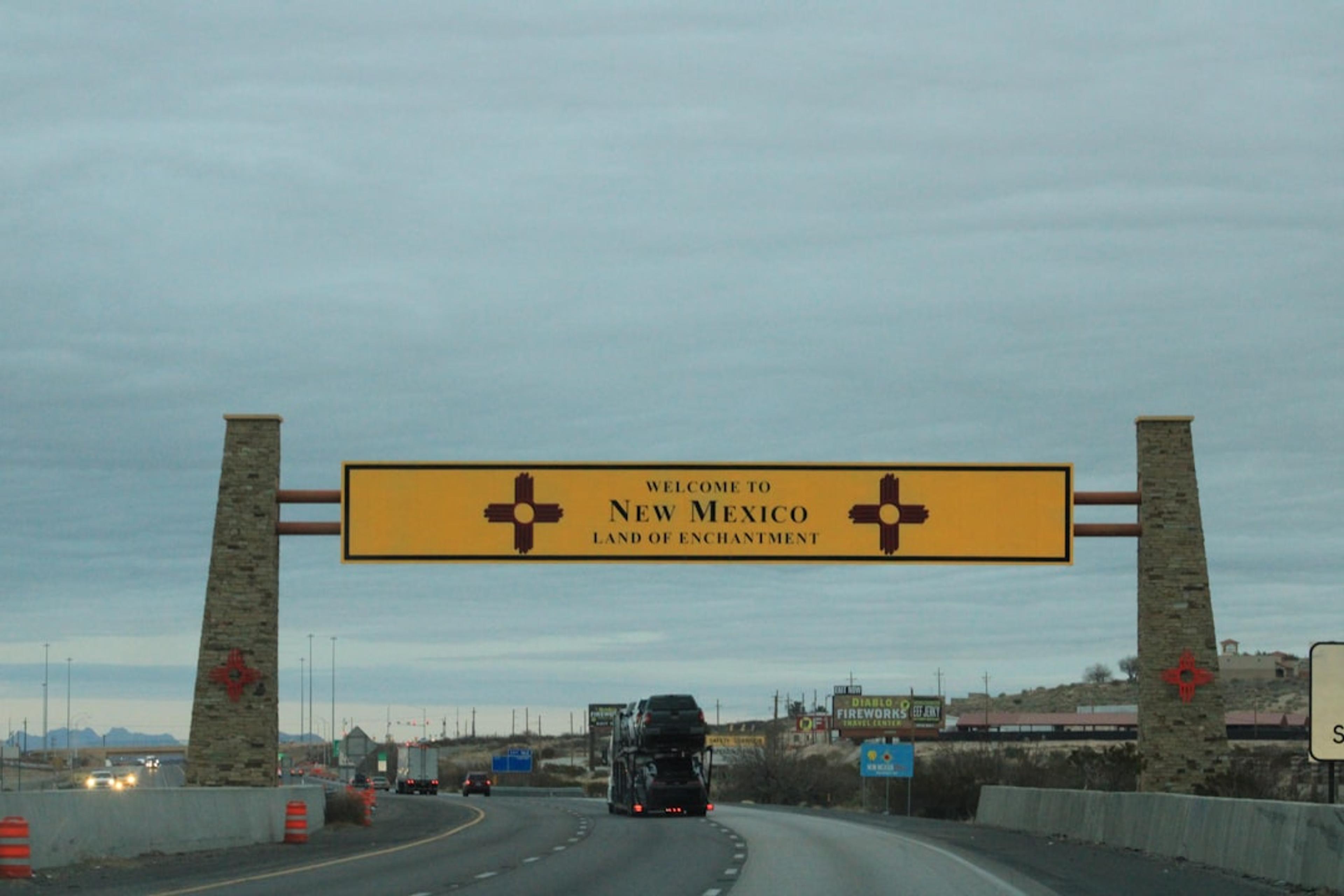a large yellow sign hanging from the side of a road