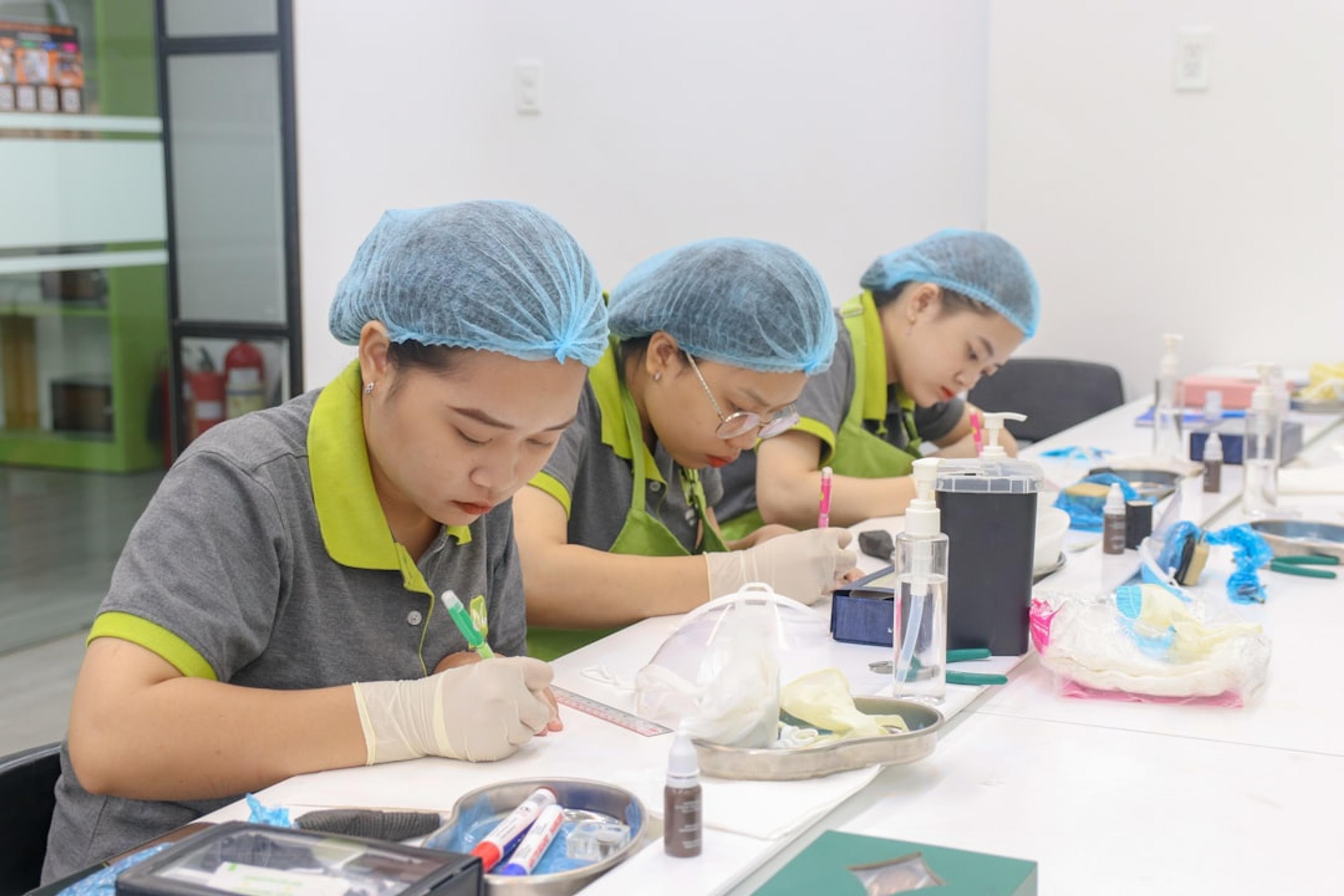 A group of people sitting at a table working on something