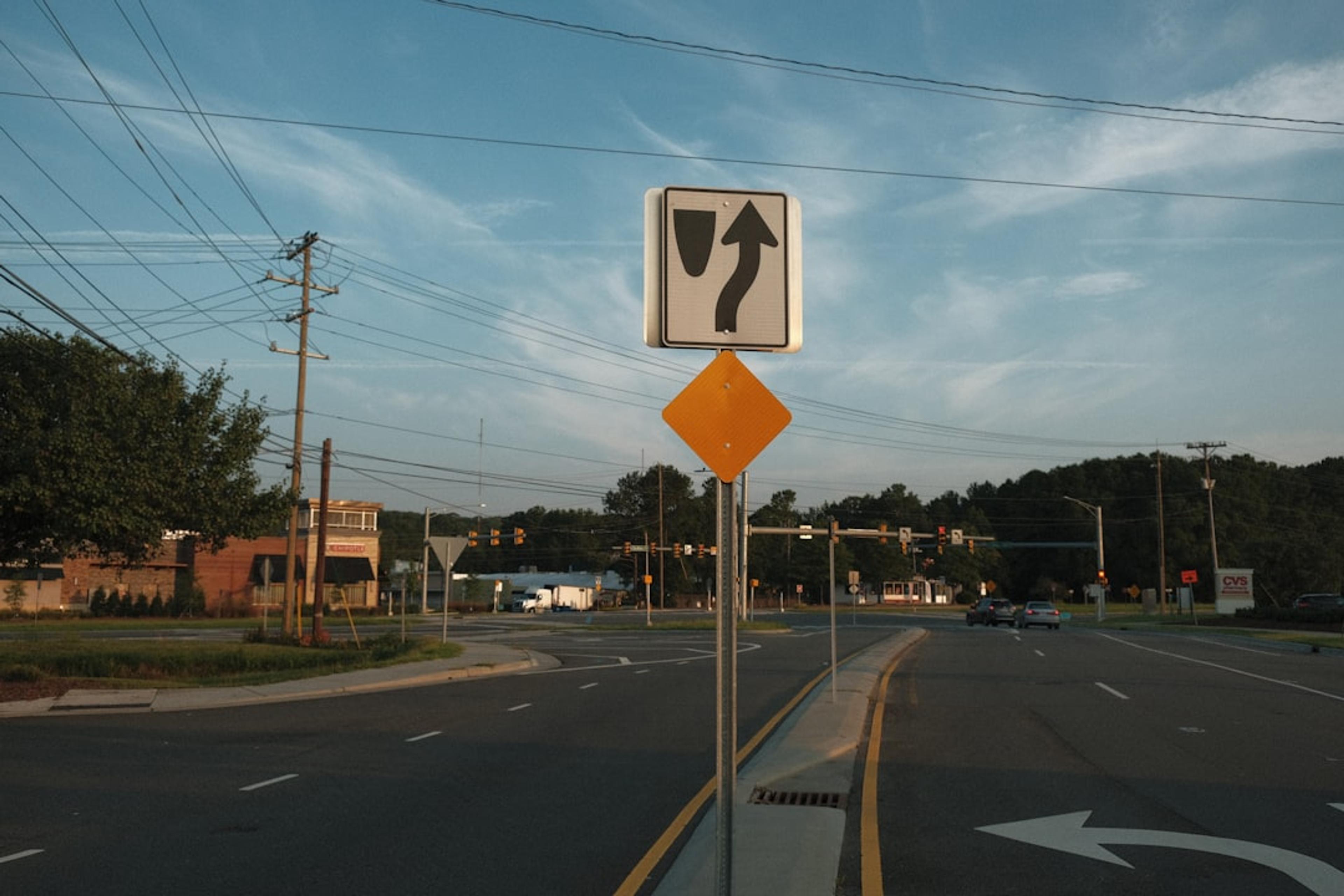 white and black pedestrian lane sign