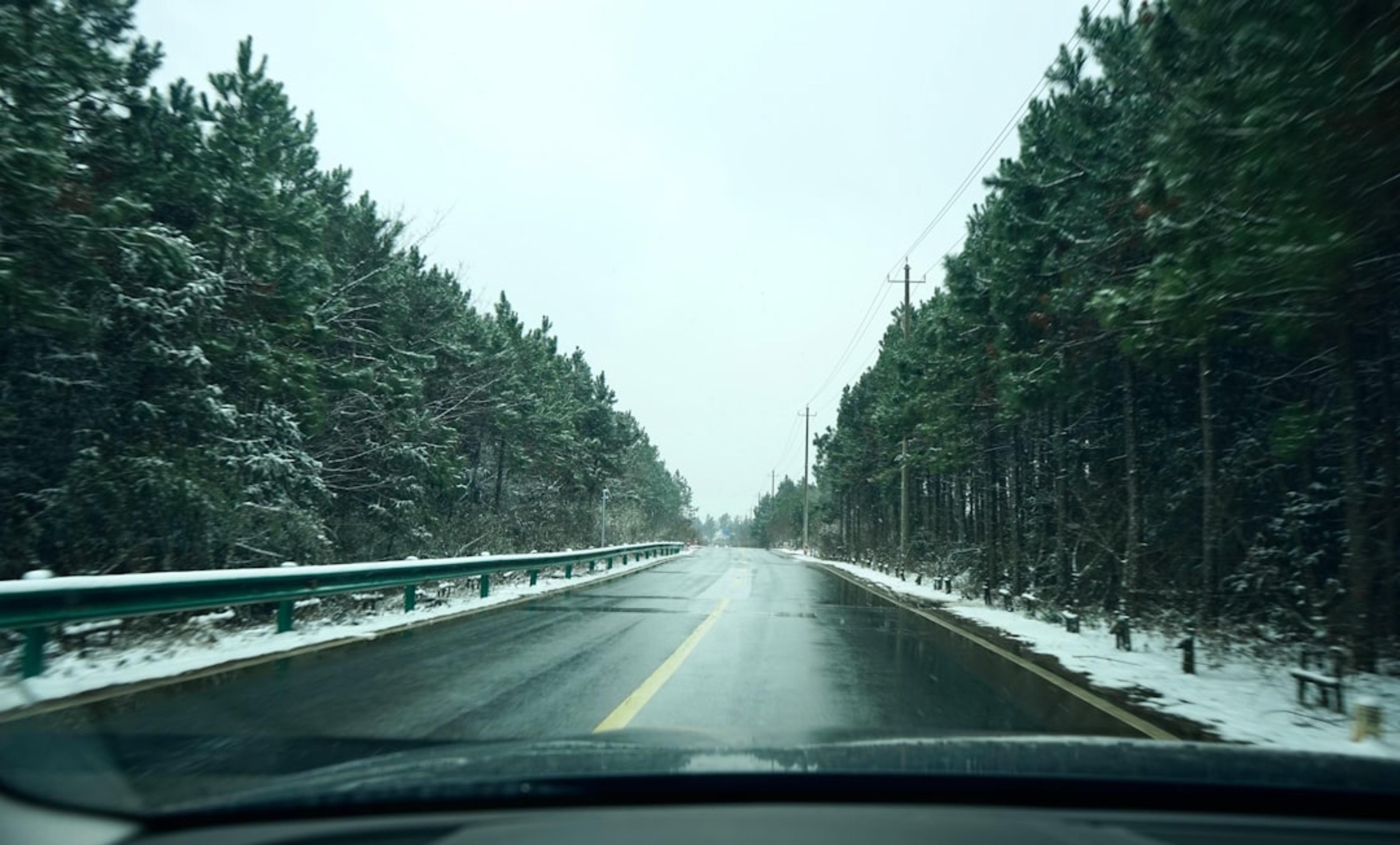 a car driving down a snow covered road