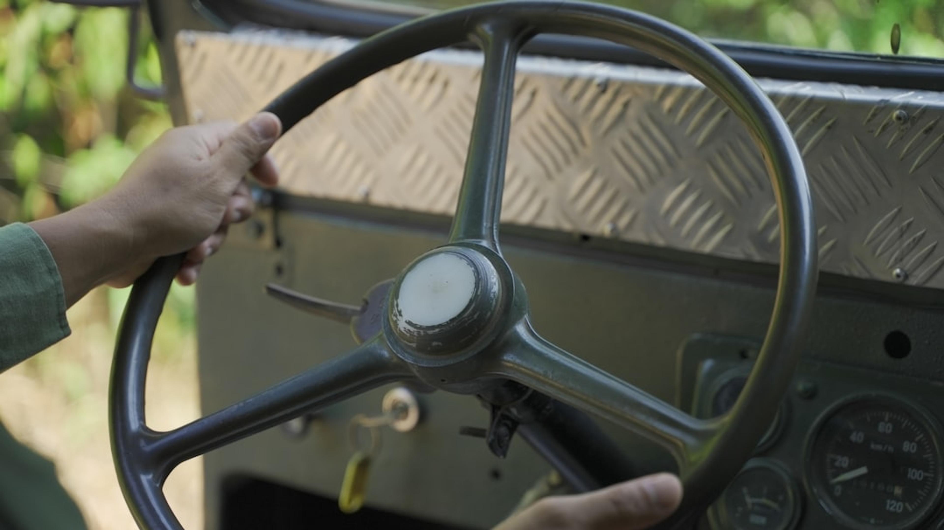 a close up of a person driving a vehicle