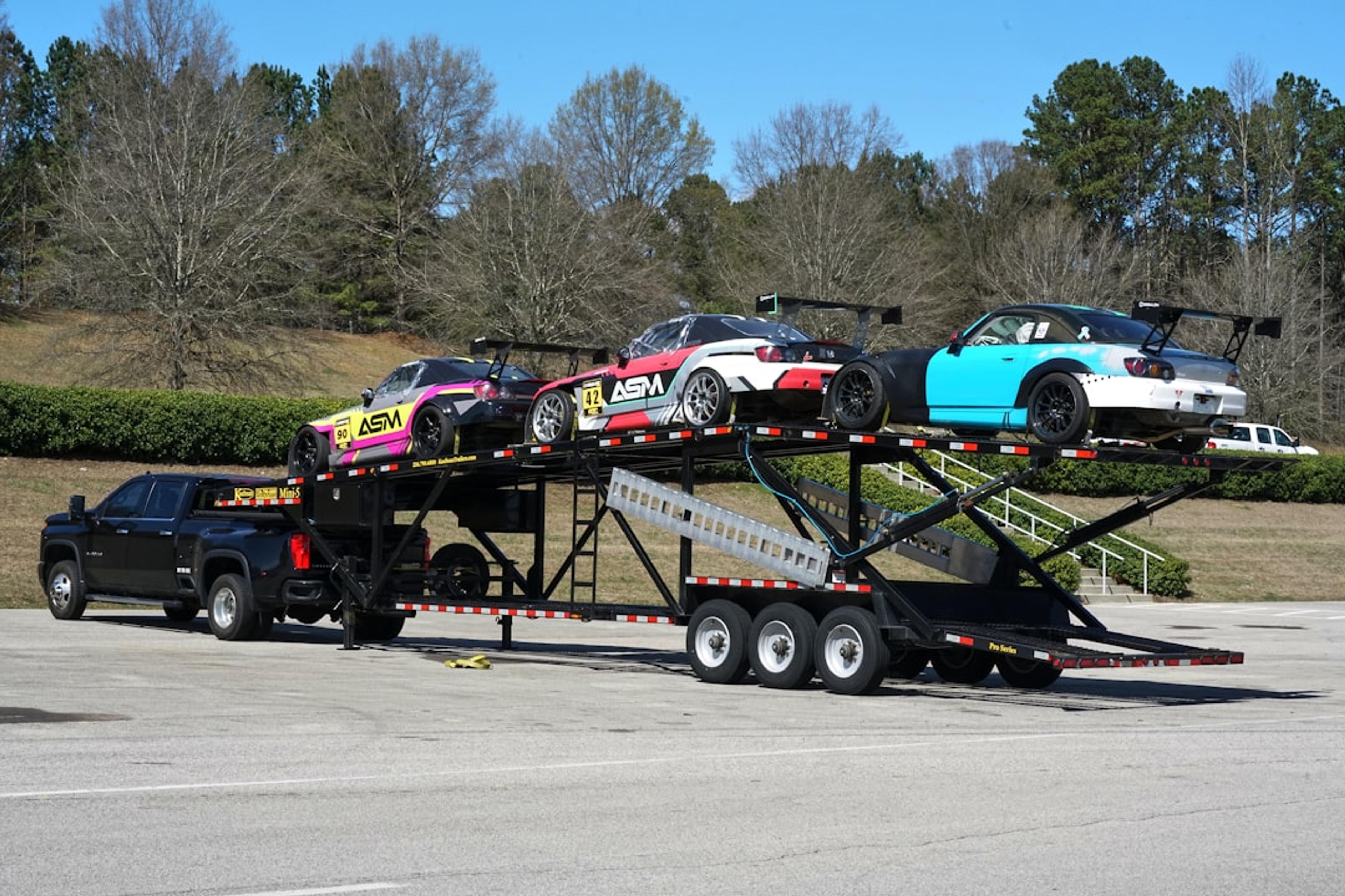 a flatbed trailer with cars on the back of it