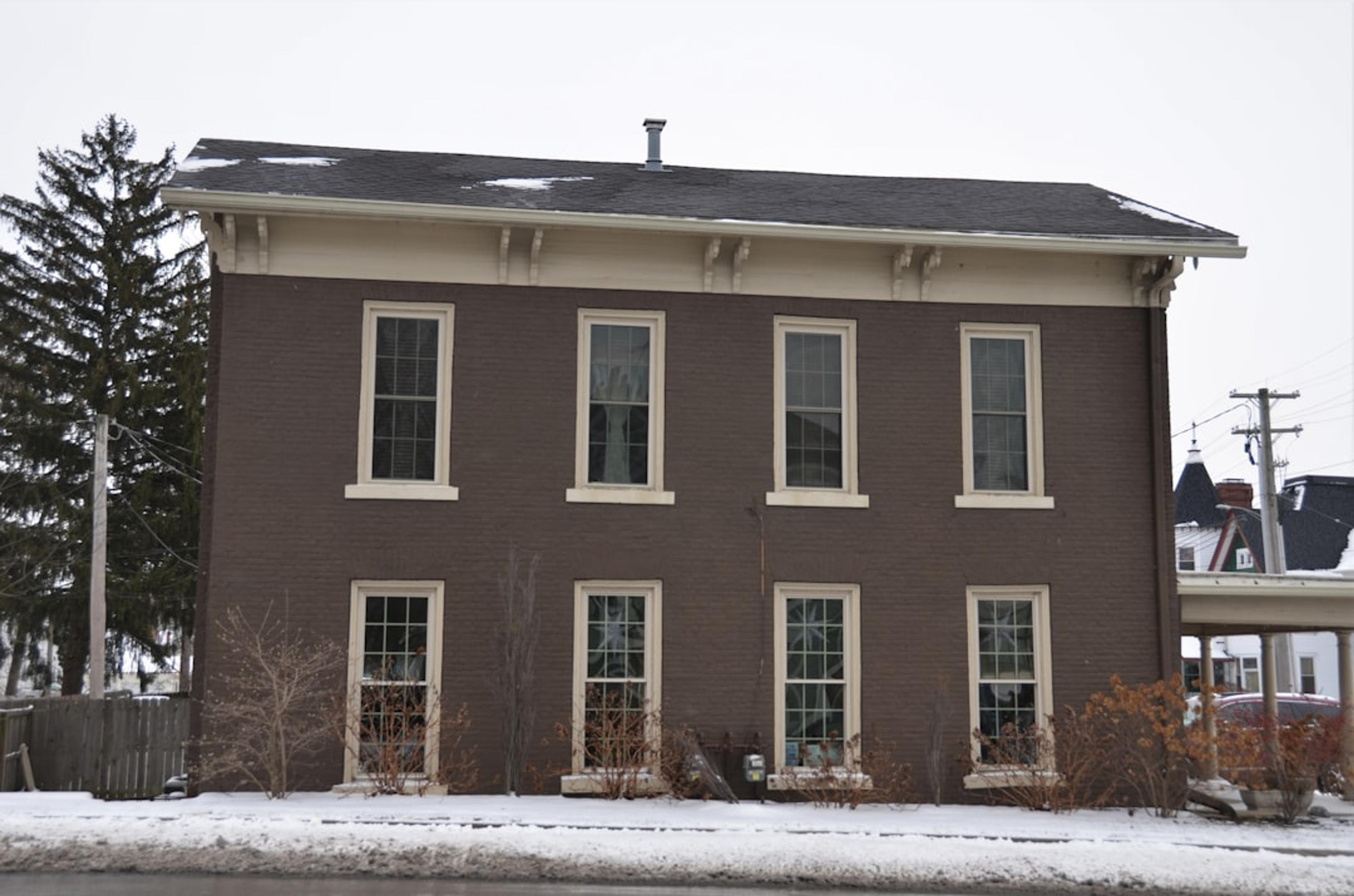 a large brown house with a lot of windows