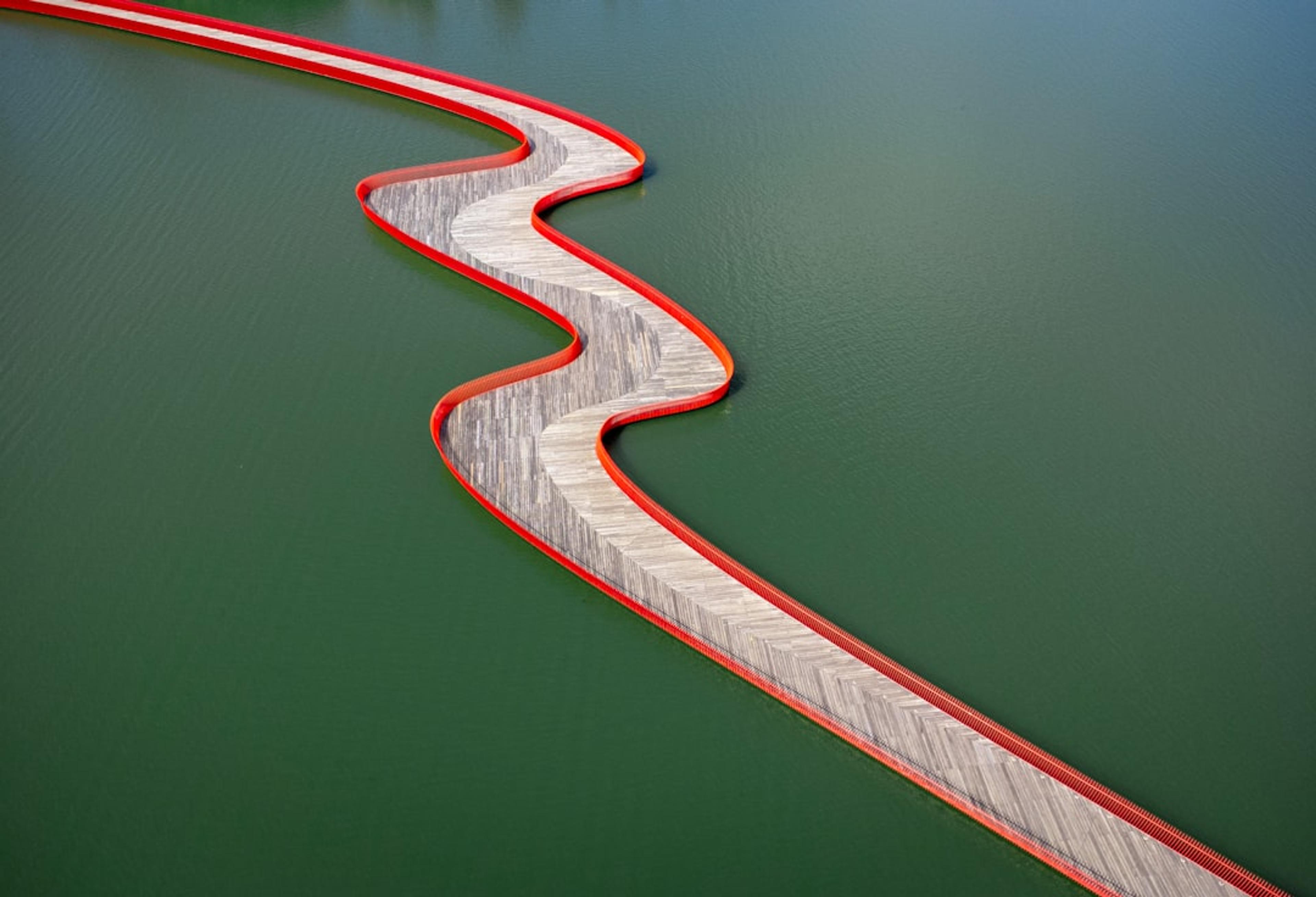A winding bridge curves over the water.