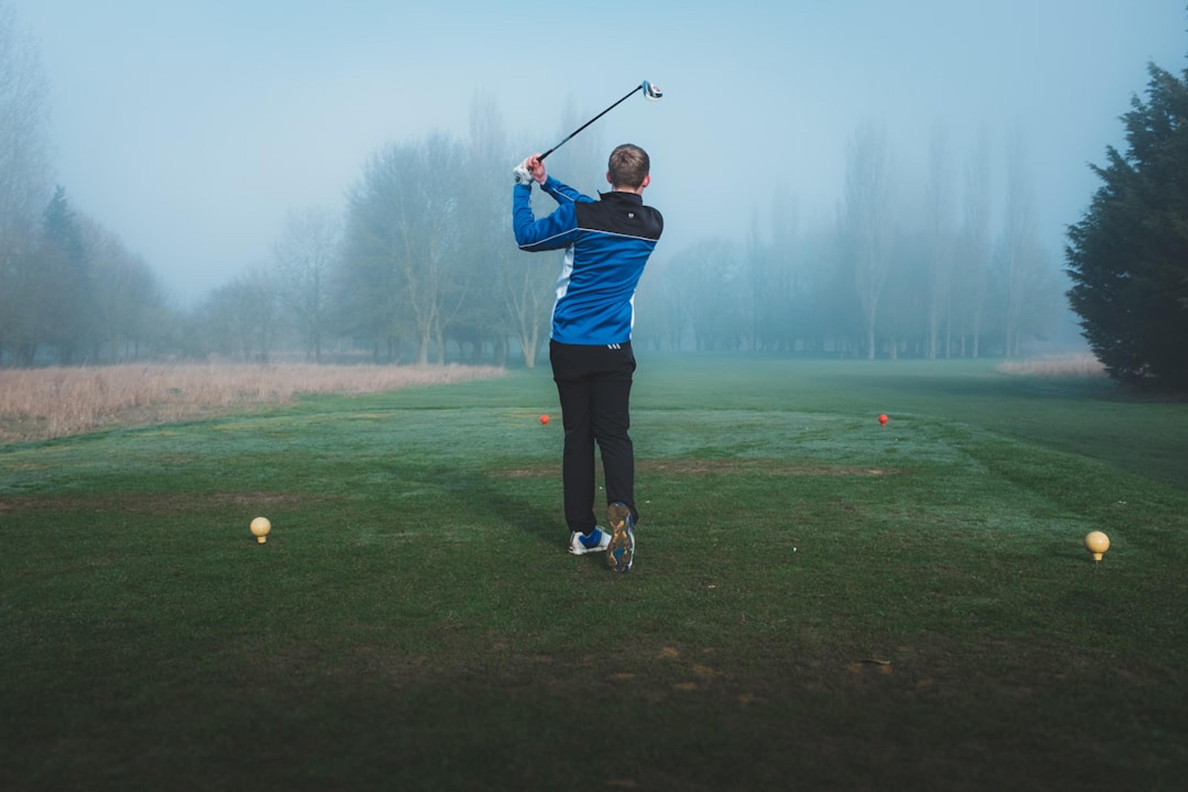 a man flying through the air on a golf course