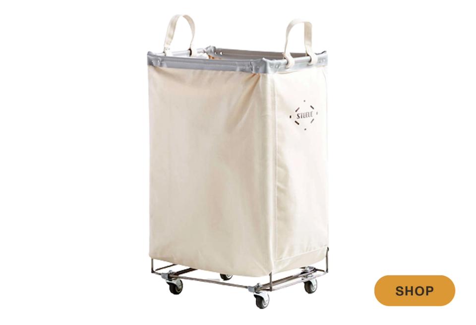 Industrial-style canvas laundry hamper with polished metal frame on wheels