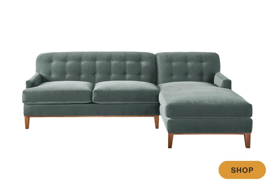 Transitional sage green sectional with button tufting and wood-tone legs