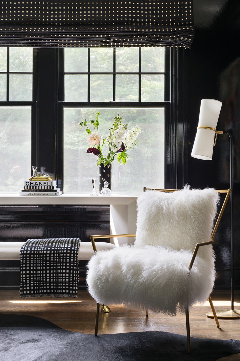 Coastal-inspired bedroom with deep teal walls, white woven hanging chair, and natural fiber accents in calming retreat setting.