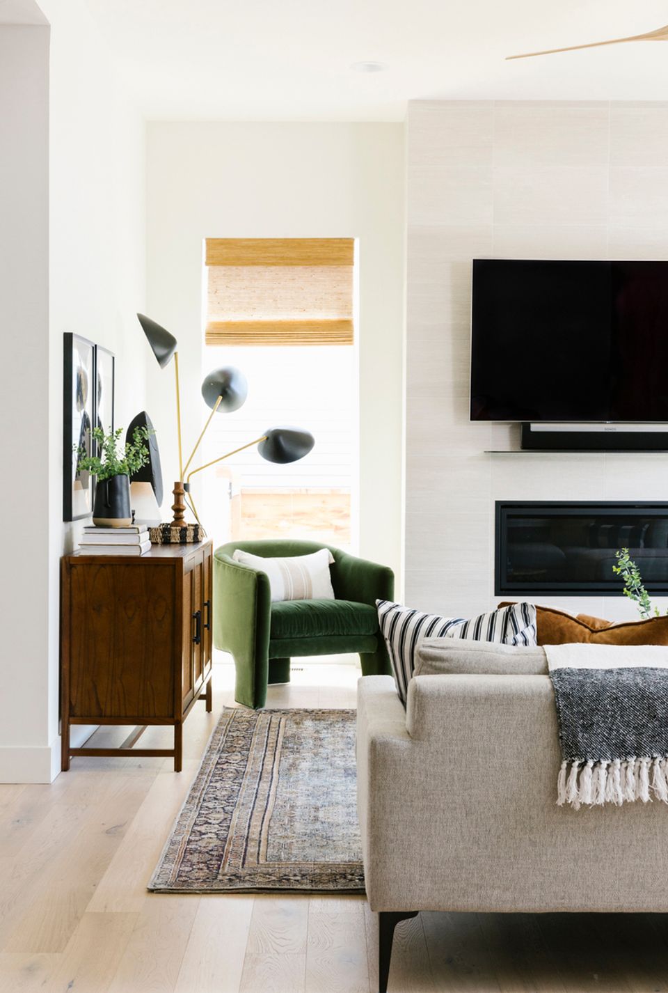 Mid-century modern living space with sculptural black arc lamp and warm wood accents