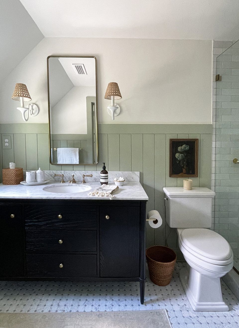 Light-filled bathroom with white shiplap, pedestal sink, and fresh green accents