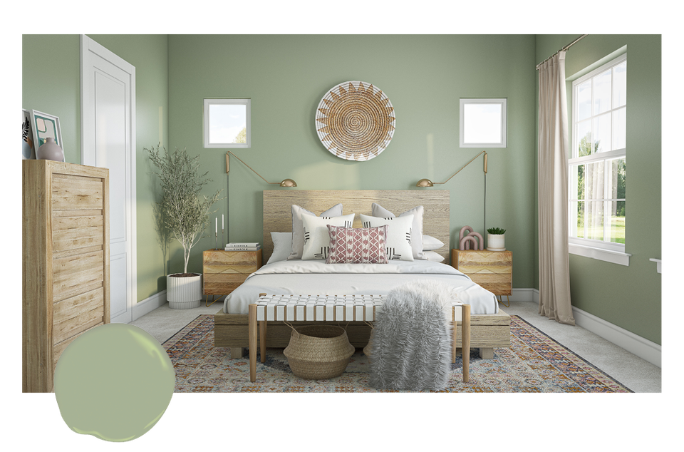 Soft sage green bedroom with natural wood accents, bohemian textiles, and bright windows creating a peaceful, airy retreat