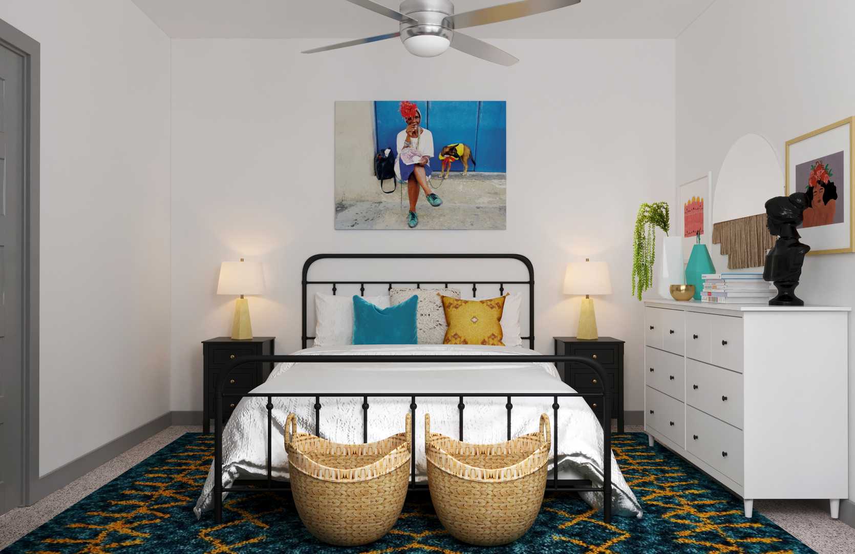 Modern bedroom with black metal bed frame, curved woven ottomans, teal and navy accents, and geometric patterned rug.