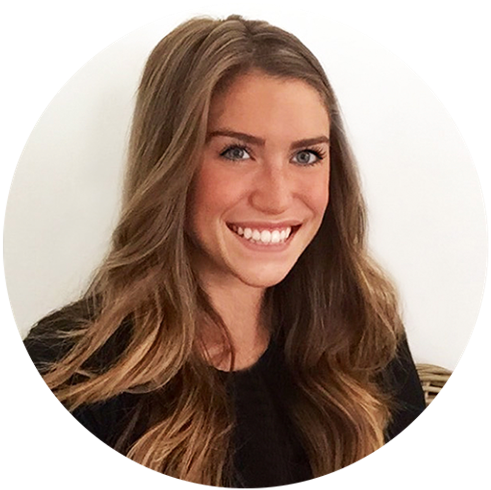 Professional headshot of woman with warm smile on neutral background