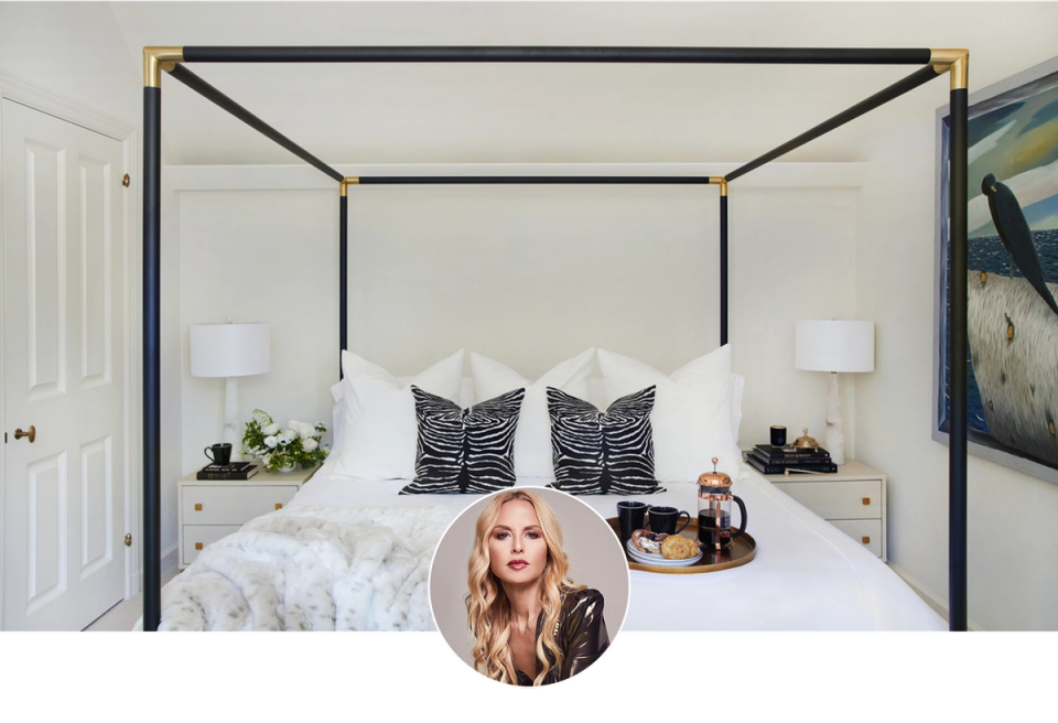 Luxe hotel-inspired bedroom with black canopy bed, crisp white linens, zebra-print pillows, and brass accents