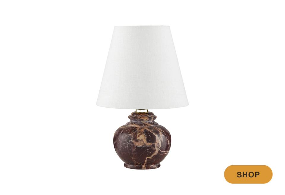 Transitional table lamp with aged ceramic base and cream shade in warm earthtones