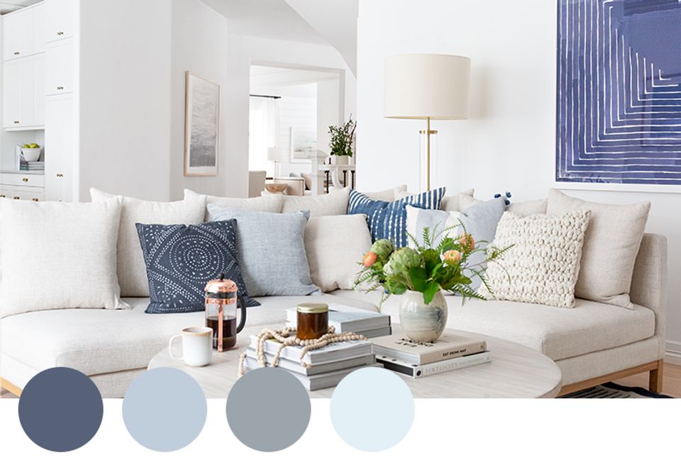Calm living room blending slate blue and soft gray tones with layered neutral textures