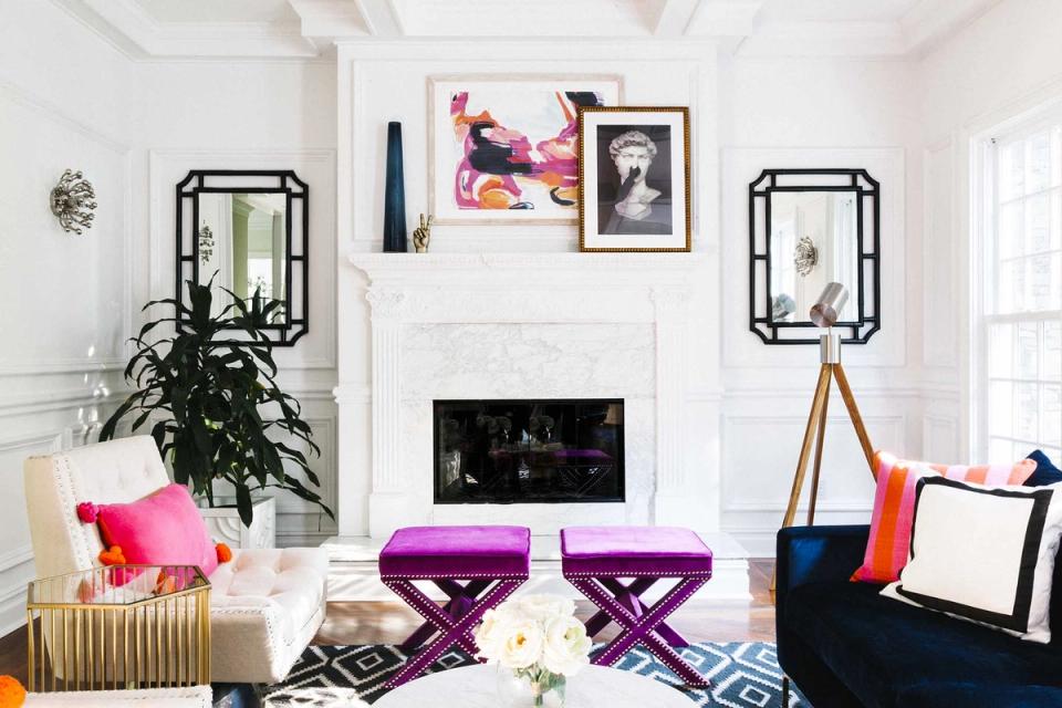 Modern living room with purple ottomans, fireplace, and contemporary eclectic decor