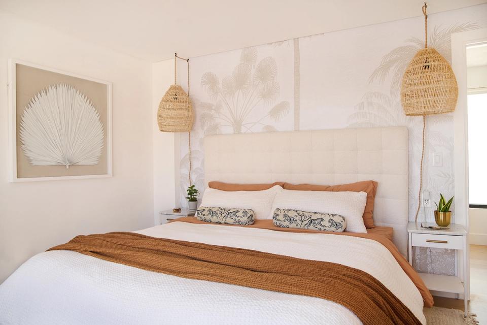 Serene boho bedroom with warm wood frame, woven pendant lights, and botanical accents