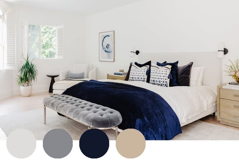 Modern bedroom blending crisp whites with deep navy accents and natural wood tones for a contemporary neutral look