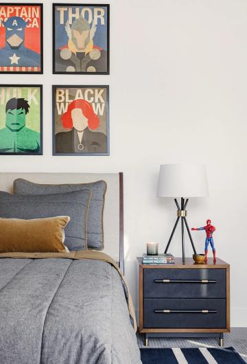 Contemporary teen bedroom featuring graphic superhero art, mid-century modern nightstand, and geometric accents