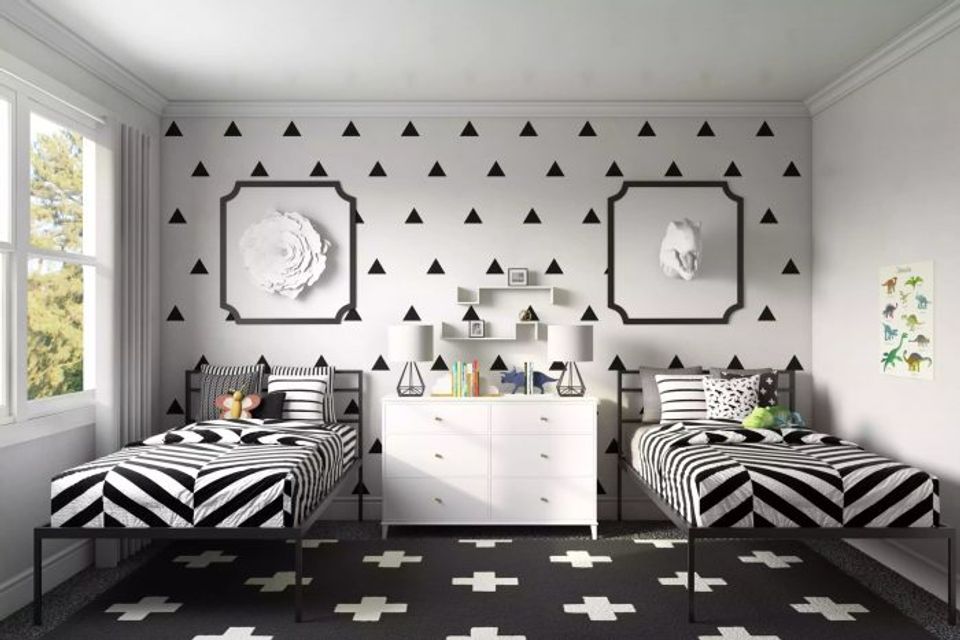 Playful shared kids' bedroom with geometric black triangle wallpaper and bold striped twin beds