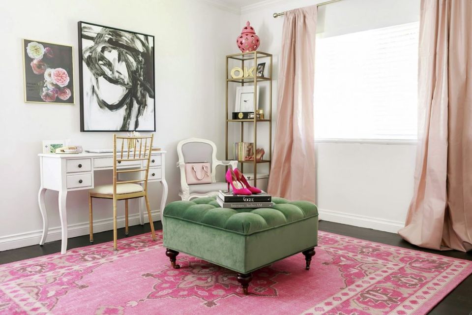 Playful girl's room blending hot pink rug, forest green ottoman, and soft white furnishings