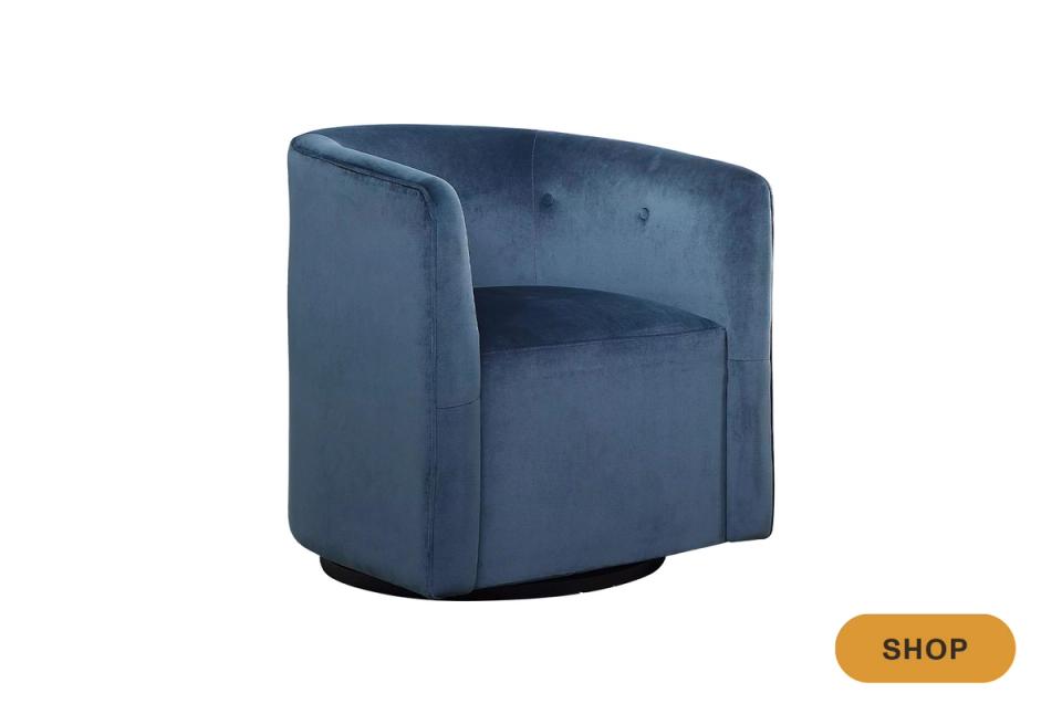 Modern blue velvet swivel chair with rounded arms and contemporary silhouette